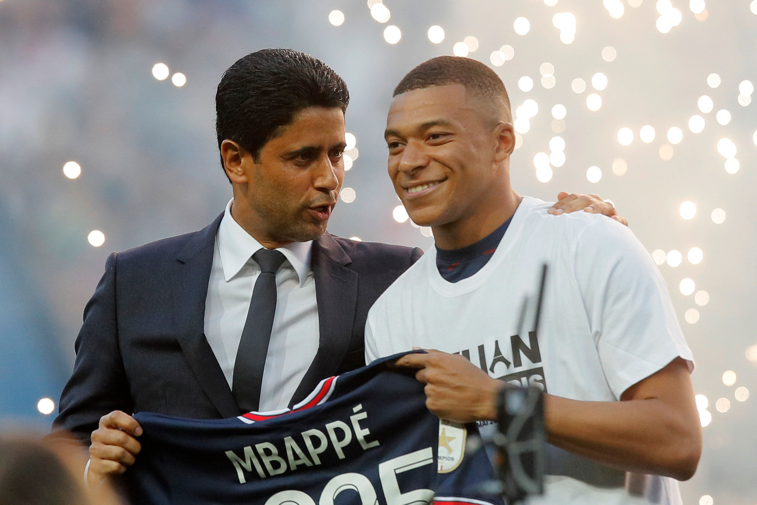 PSG President Nasser Al-Khelaifi, left, speaks to PSG's Kylian Mbappe as it is announced he has signed a three year extension to his contract, at the Parc des Princes stadium in Paris, France, Saturday, May 21, 2022. (AP Photo/Michel Spingler, File)