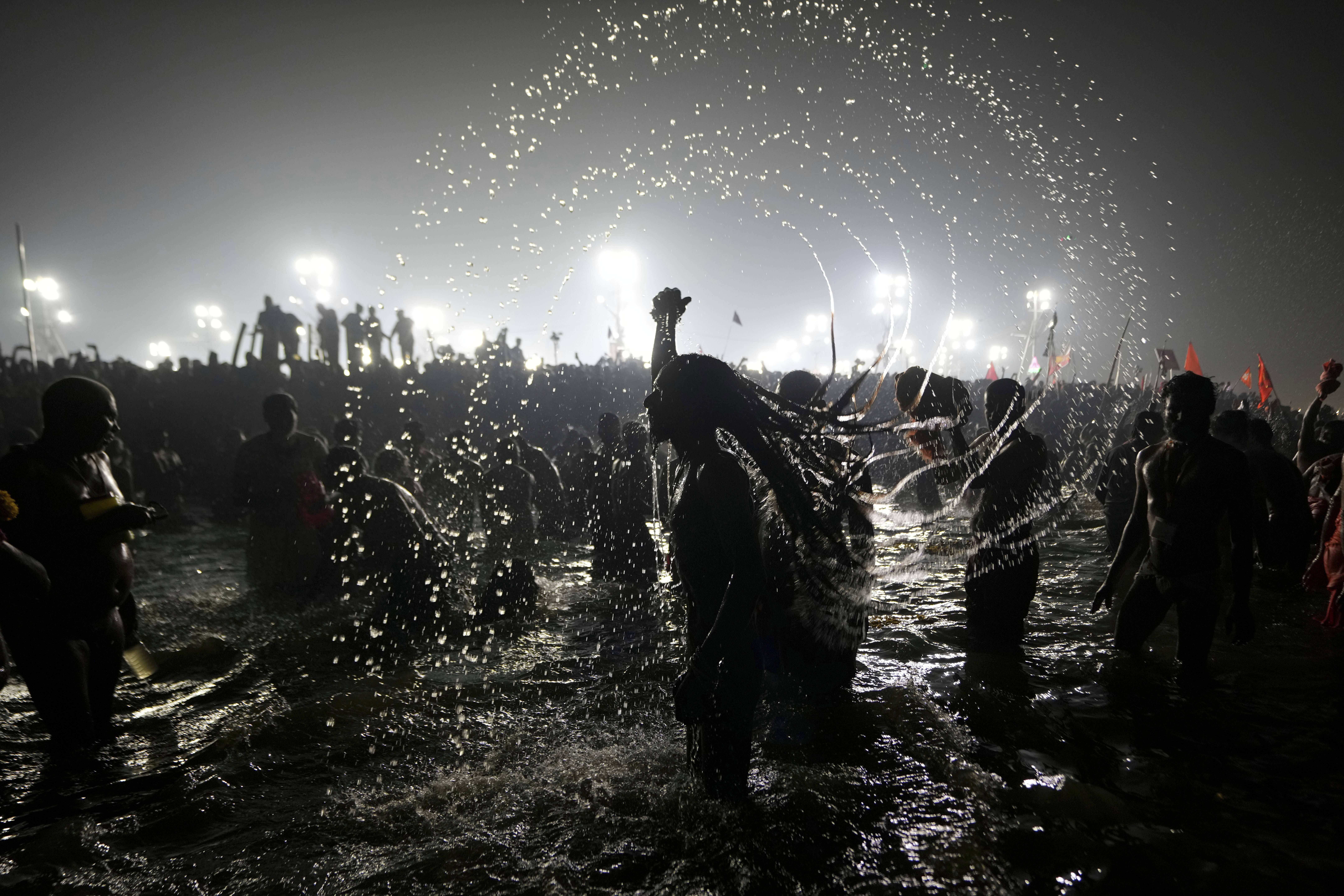 Hindu holy men bathe in the Sangam in Prayagraj, India. 