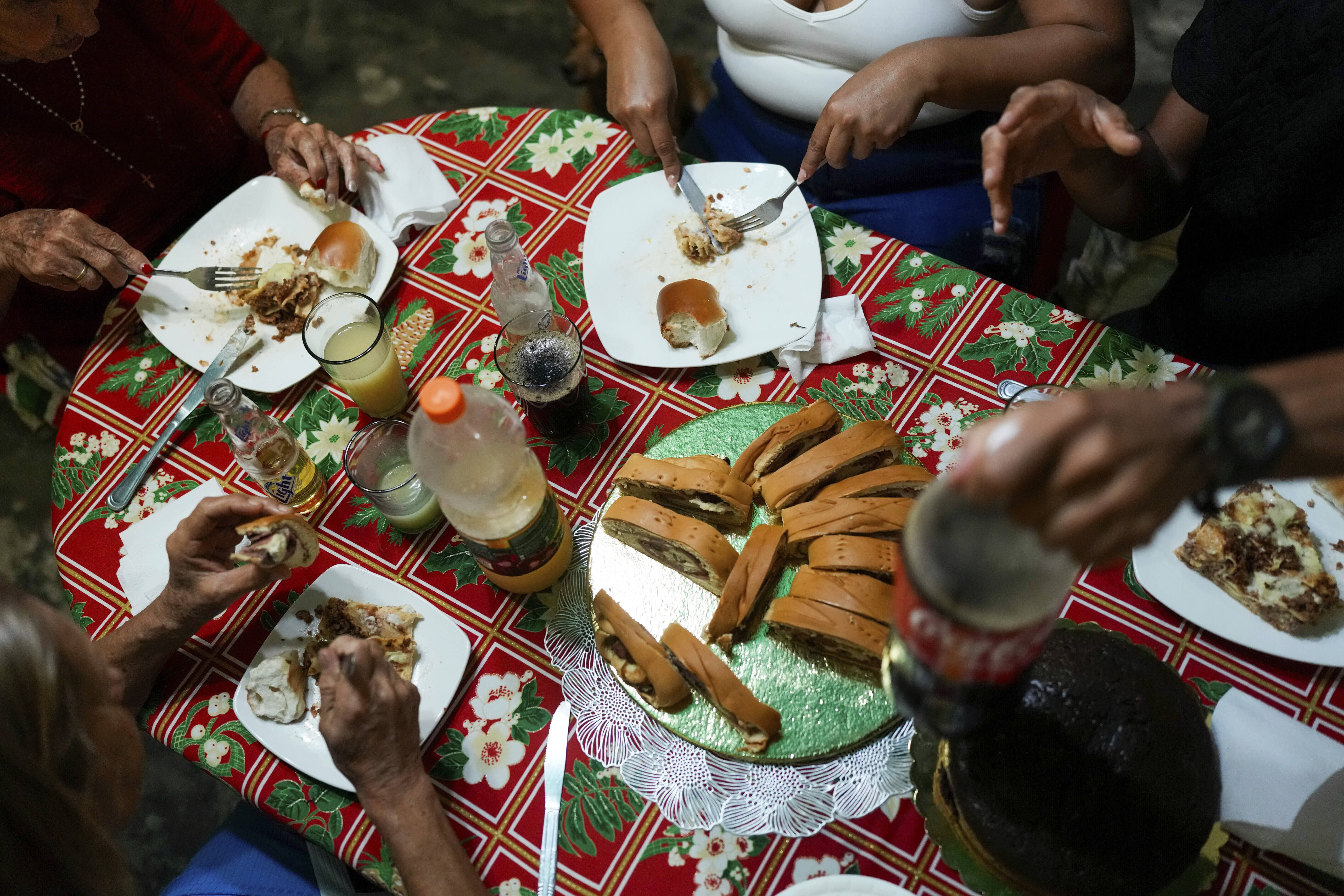A migrant couple share a modest Christmas dinner with family in Maracay. 