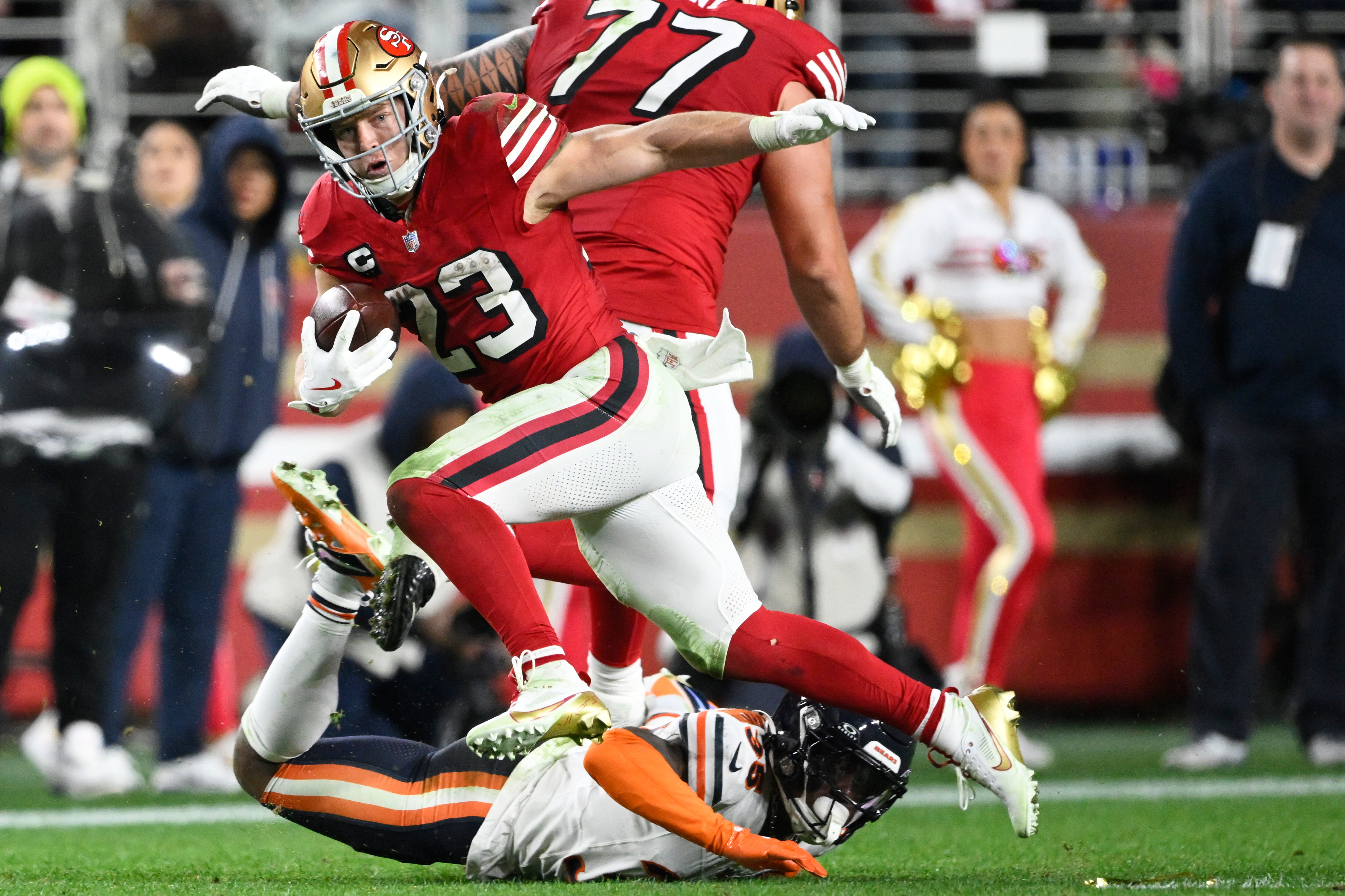 San Francisco 49ers running back Christian McCaffrey (23) runs against Chicago Bears safety C.J. Gardner-Johnson, bottom, during the second half of an NFL football game in Santa Clara, Calif., Sunday, Dec. 28, 2025.