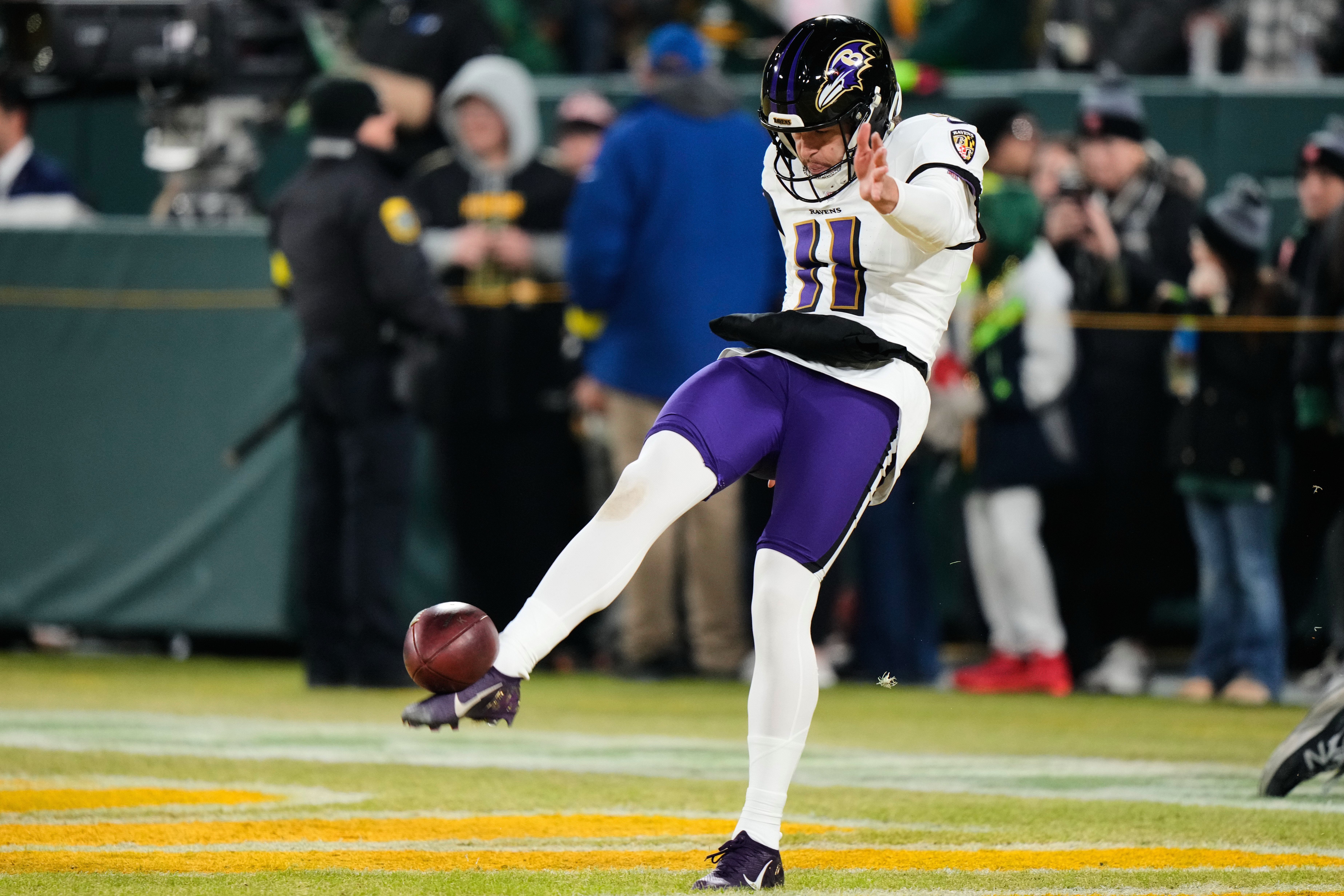 Baltimore Ravens punter Jordan Stout (11) warms up before an NFL football game against the Green Bay Packers, Saturday, Dec. 27, 2025, in Green Bay, Wis.