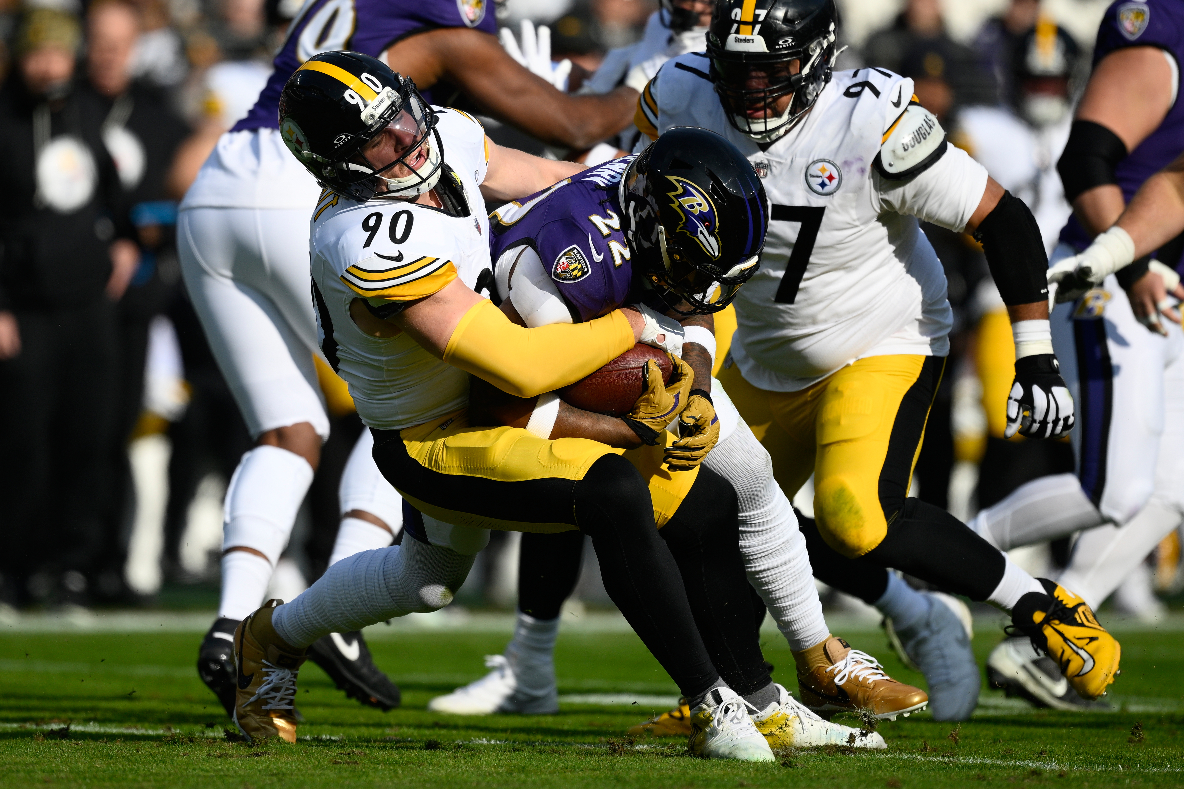 Pittsburgh Steelers linebacker T.J. Watt (90) tackles Baltimore Ravens running back Derrick Henry (22) during the first half of an NFL football game, Sunday, Dec. 7, 2025, in Baltimore.