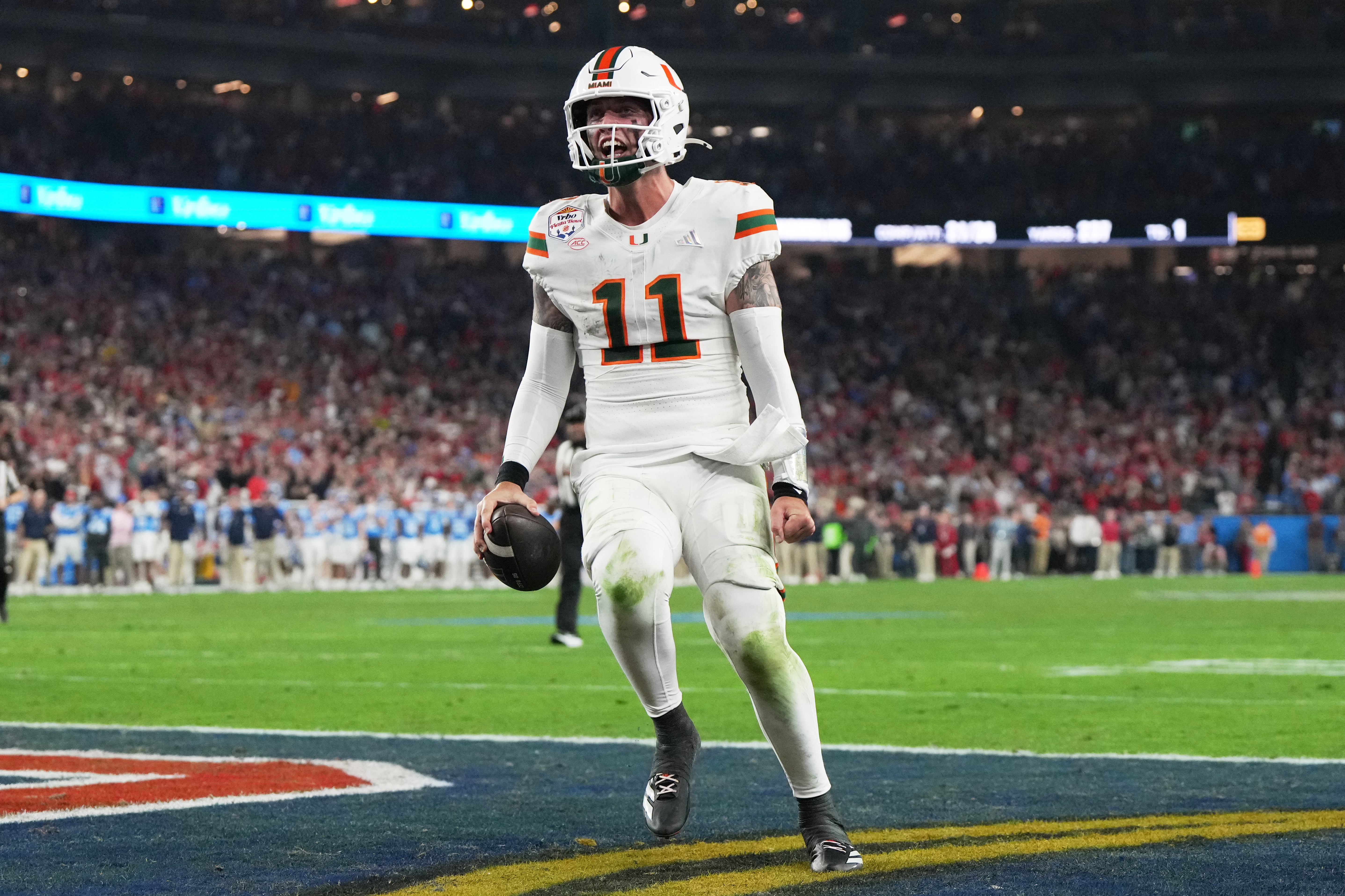 Miami quarterback Carson Beck scores a touchdown during the second half of the Fiesta Bowl NCAA college football playoff semifinal game against Mississippi, Thursday, Jan. 8, 2026, in Glendale, Ariz.