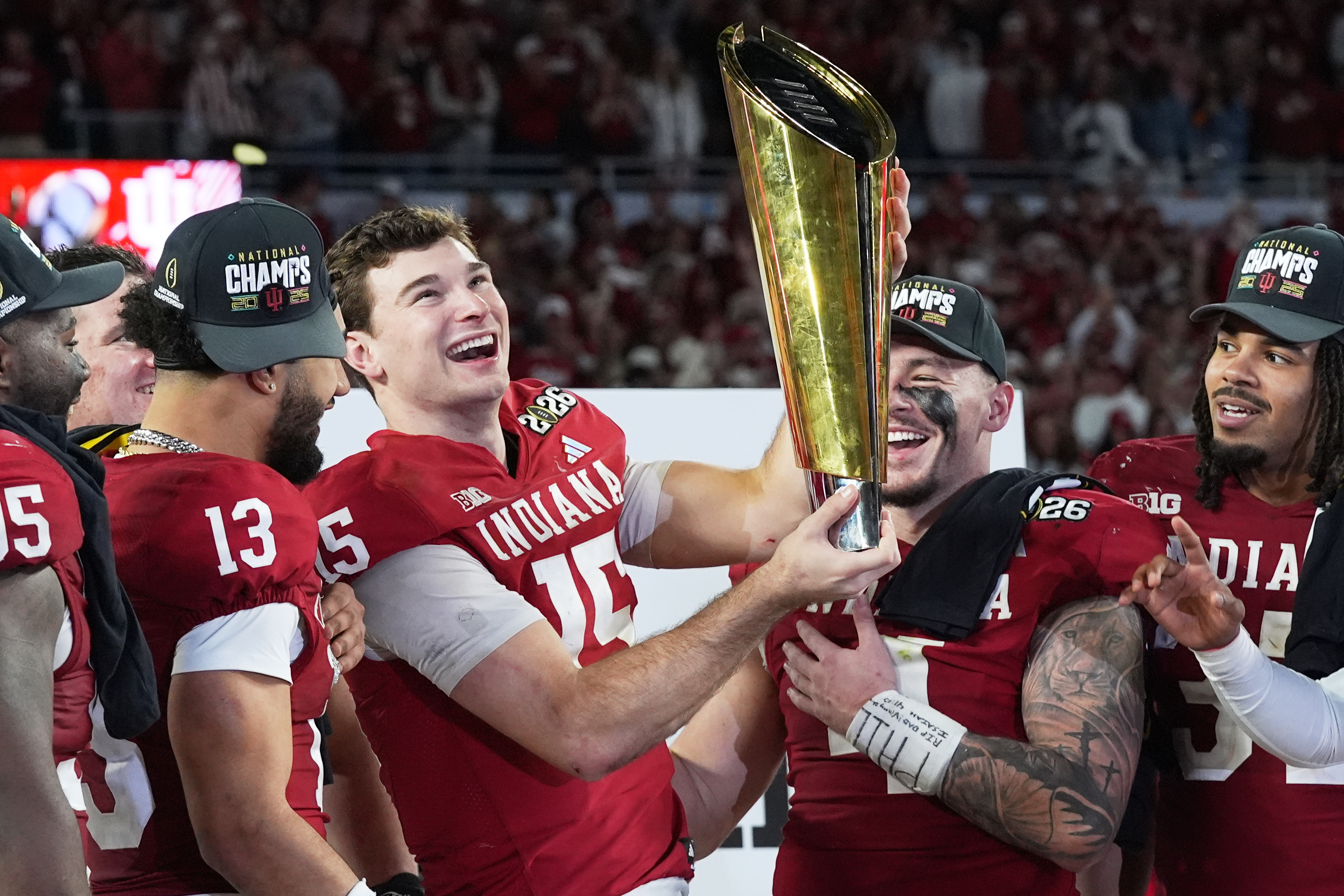 Indiana quarterback Fernando Mendoza holds the trophy after their win against Miami in the College Football Playoff national championship game, Monday, Jan. 19, 2026, in Miami Gardens, Fla.