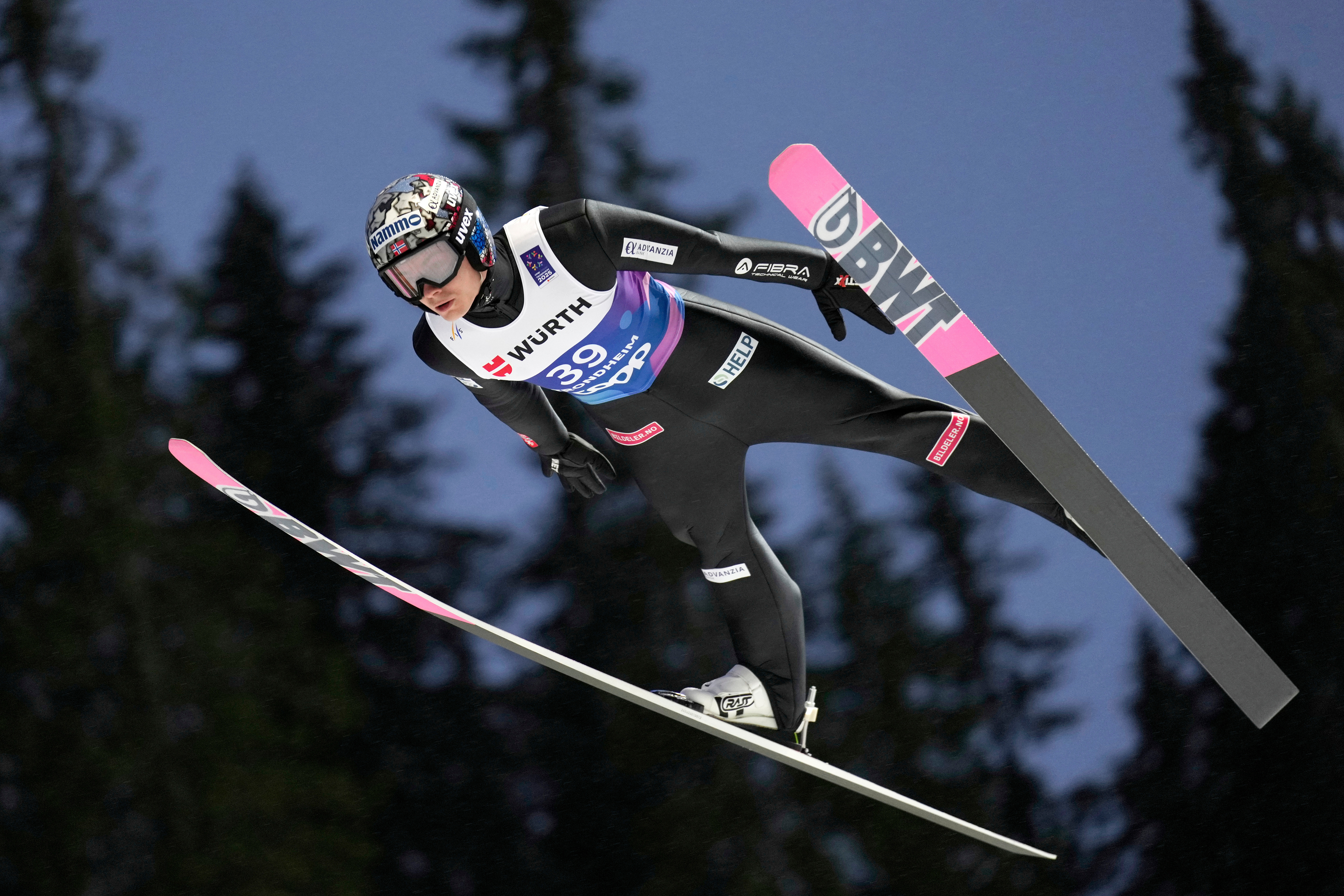 Marius Lindvik, of Norway, soars through the air during his first round jump of the ski jumping men's normal hill HS102 event at the Nordic World Ski Championships in Trondheim, Norway, Sunday, March 2, 2025. (AP Photo/Matthias Schrader, File)