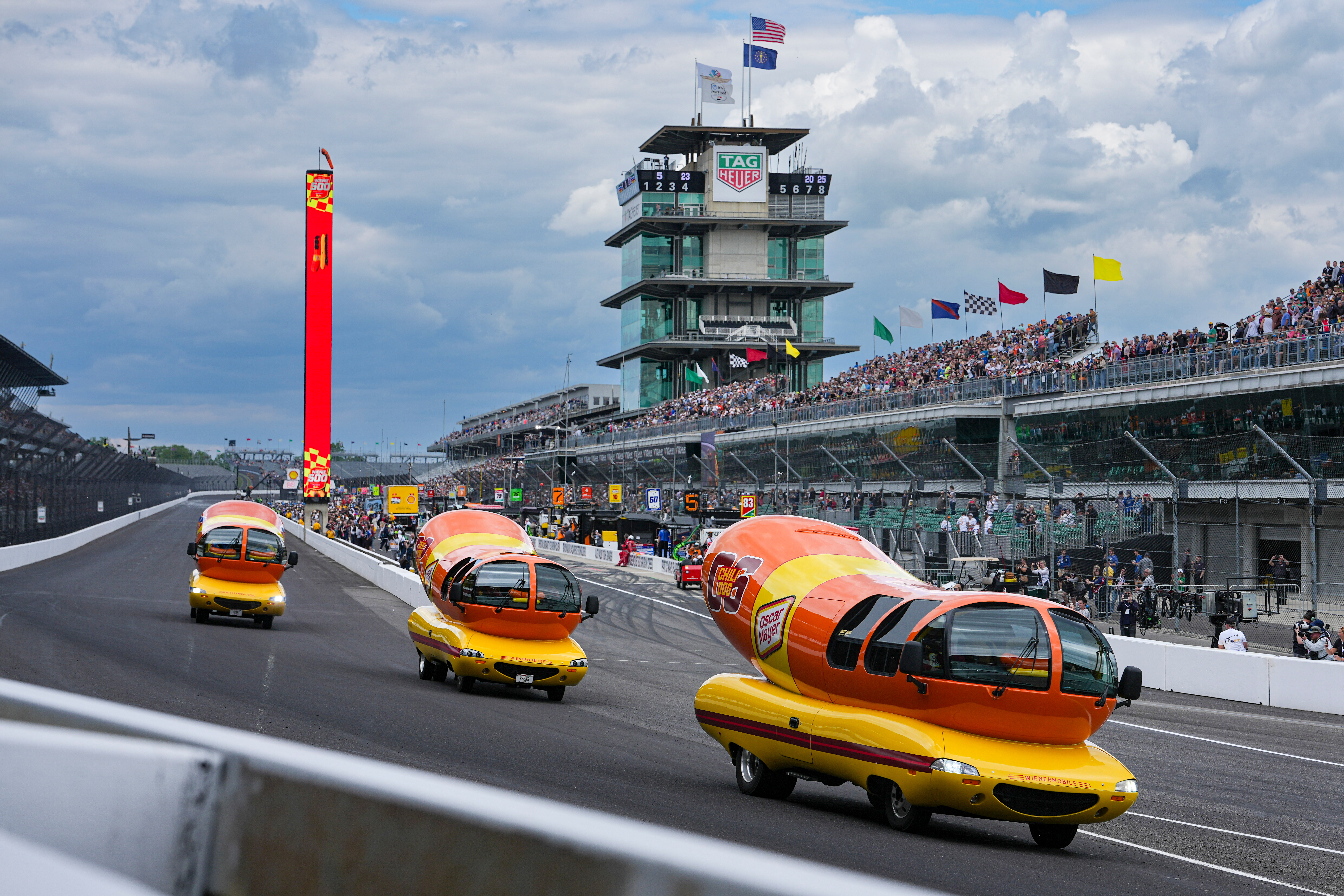 Oscar Mayer Wienermobiles head into the first turn as they compete in the Wienie 500 following the practice session for the Indianapolis 500 auto race at Indianapolis Motor Speedway in Indianapolis, in 2025. (AP Photo/Michael Conroy).