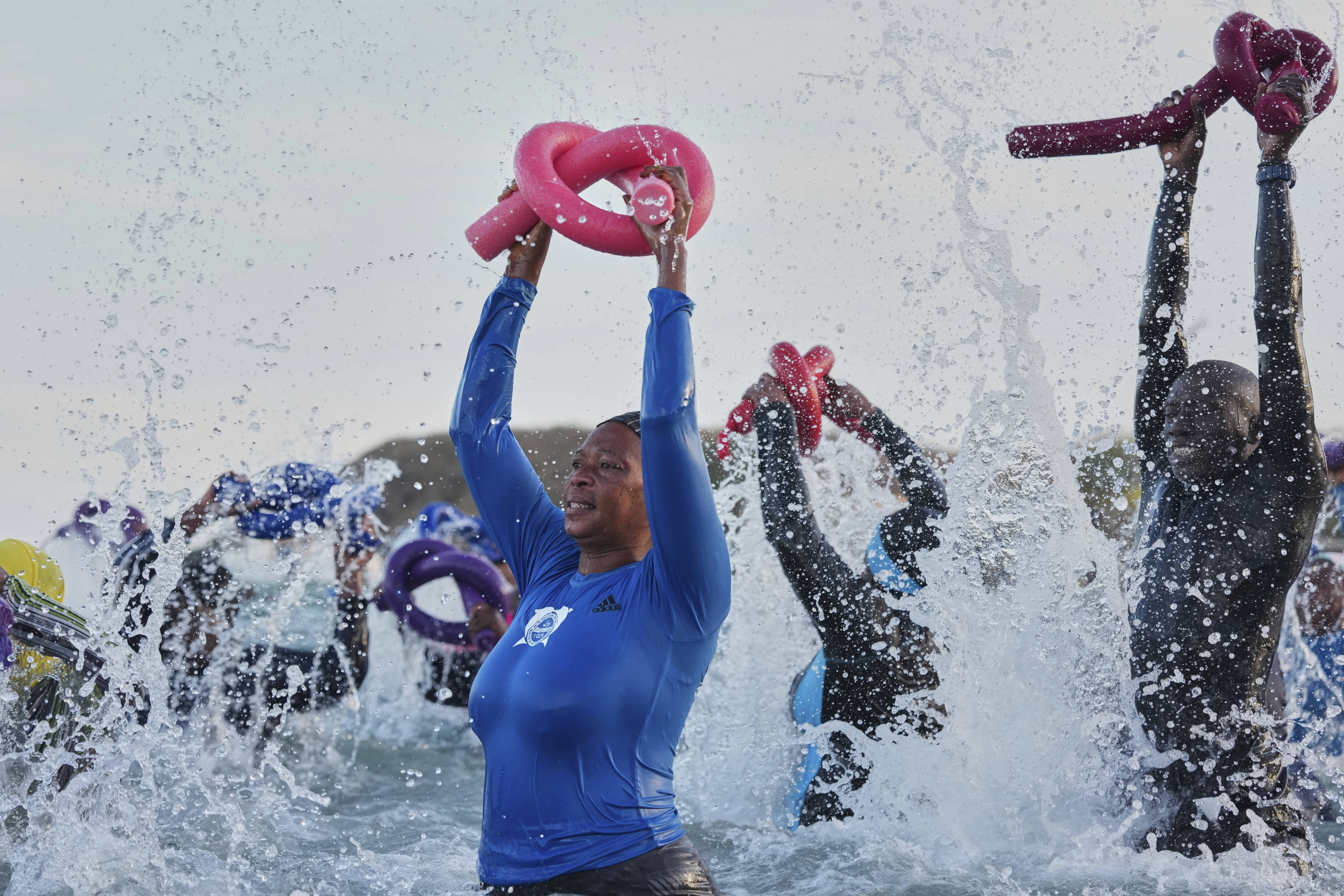 People take part in a group aquatic therapy session in the Atlantic Ocean in Dakar. 
