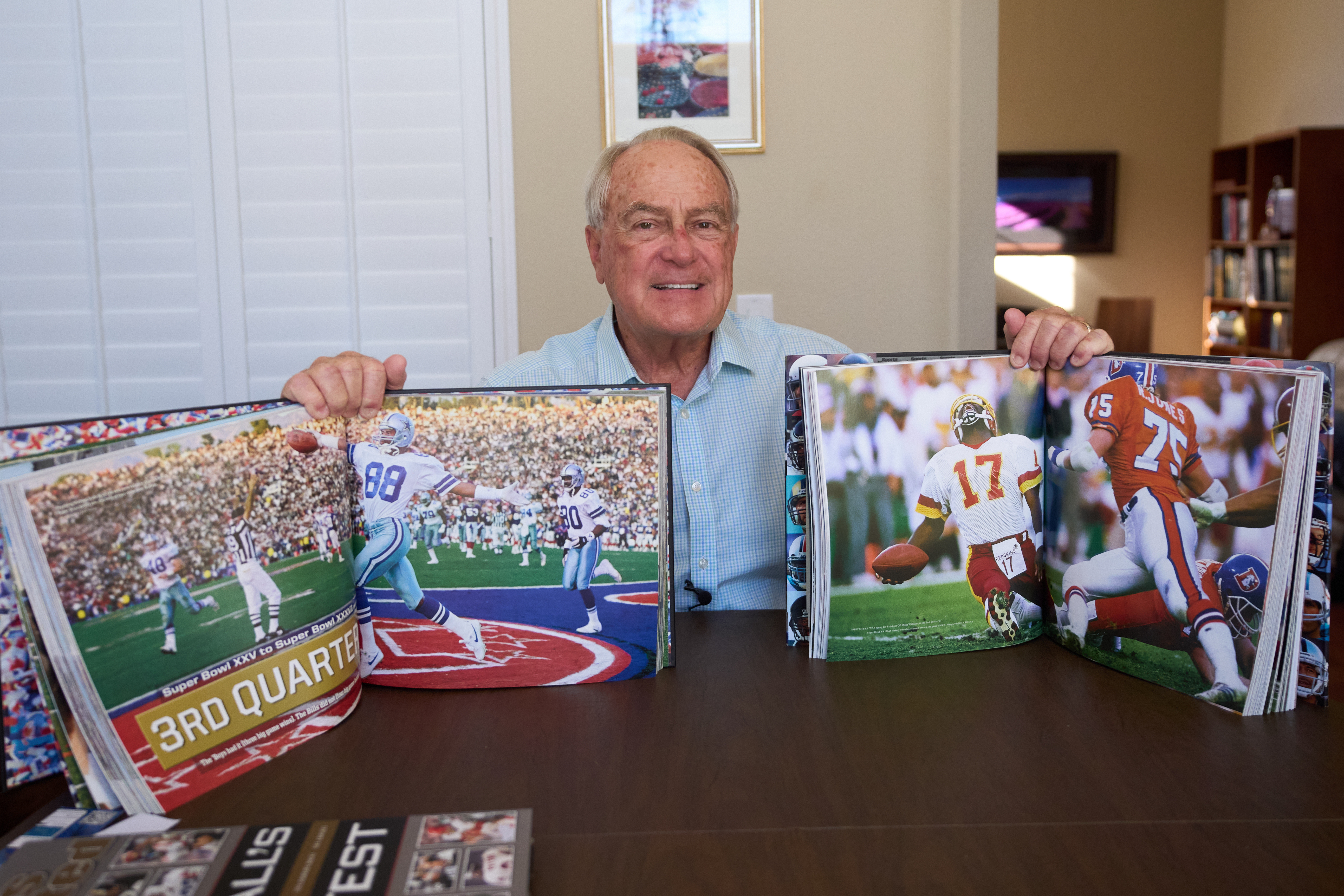 Photographer John Biever, who has shot every Super Bowl NFL football game, holds images he has made from previous bowl games at his home Tuesday, Jan. 20, 2026, in San Diego.
