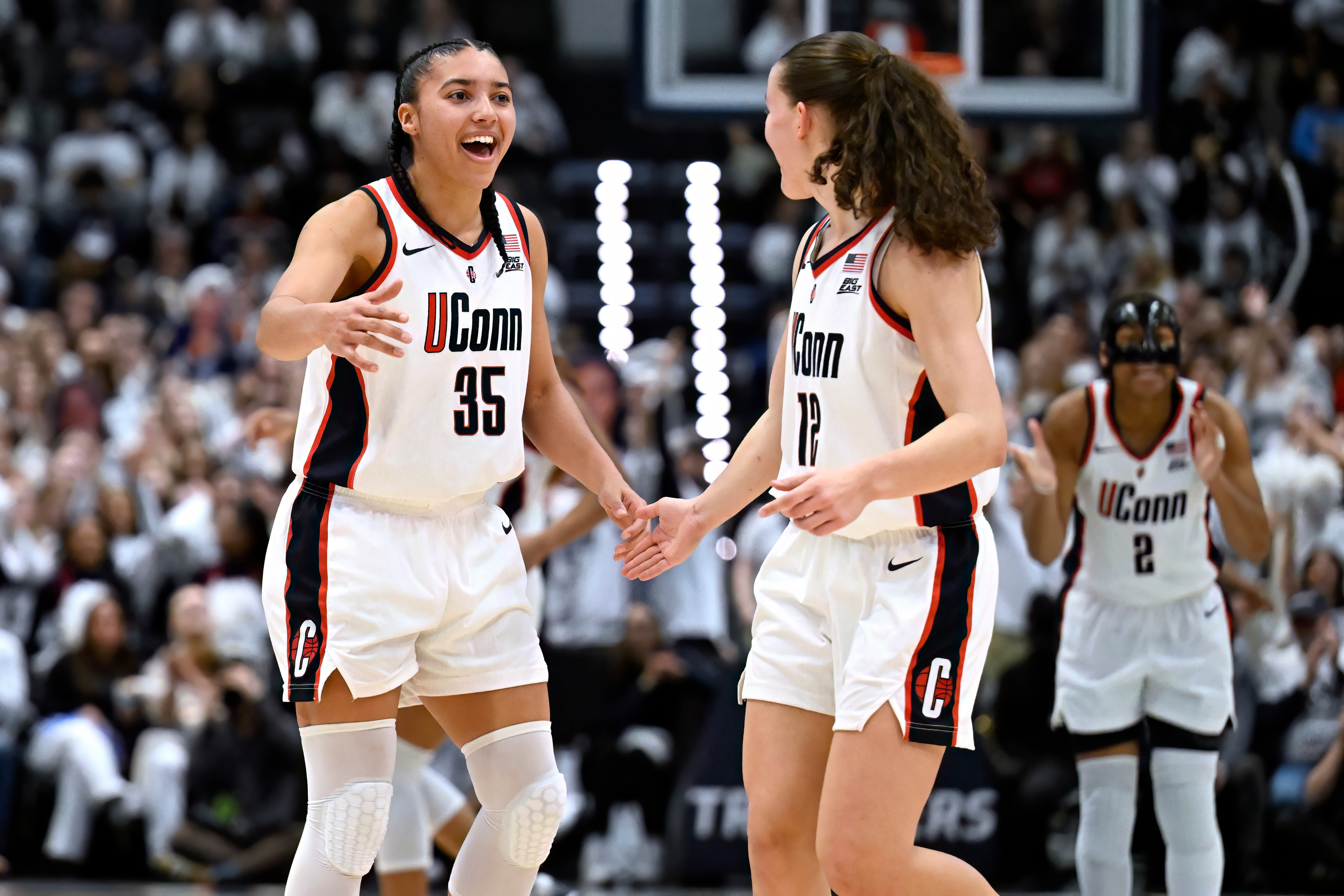 UConn guard Azzi Fudd (35) celebrates with guard Ashlynn Shade (12) in the second half of an NCAA college basketball game against Tennessee, Sunday, Feb. 1, 2026, in Hartford, Conn.
