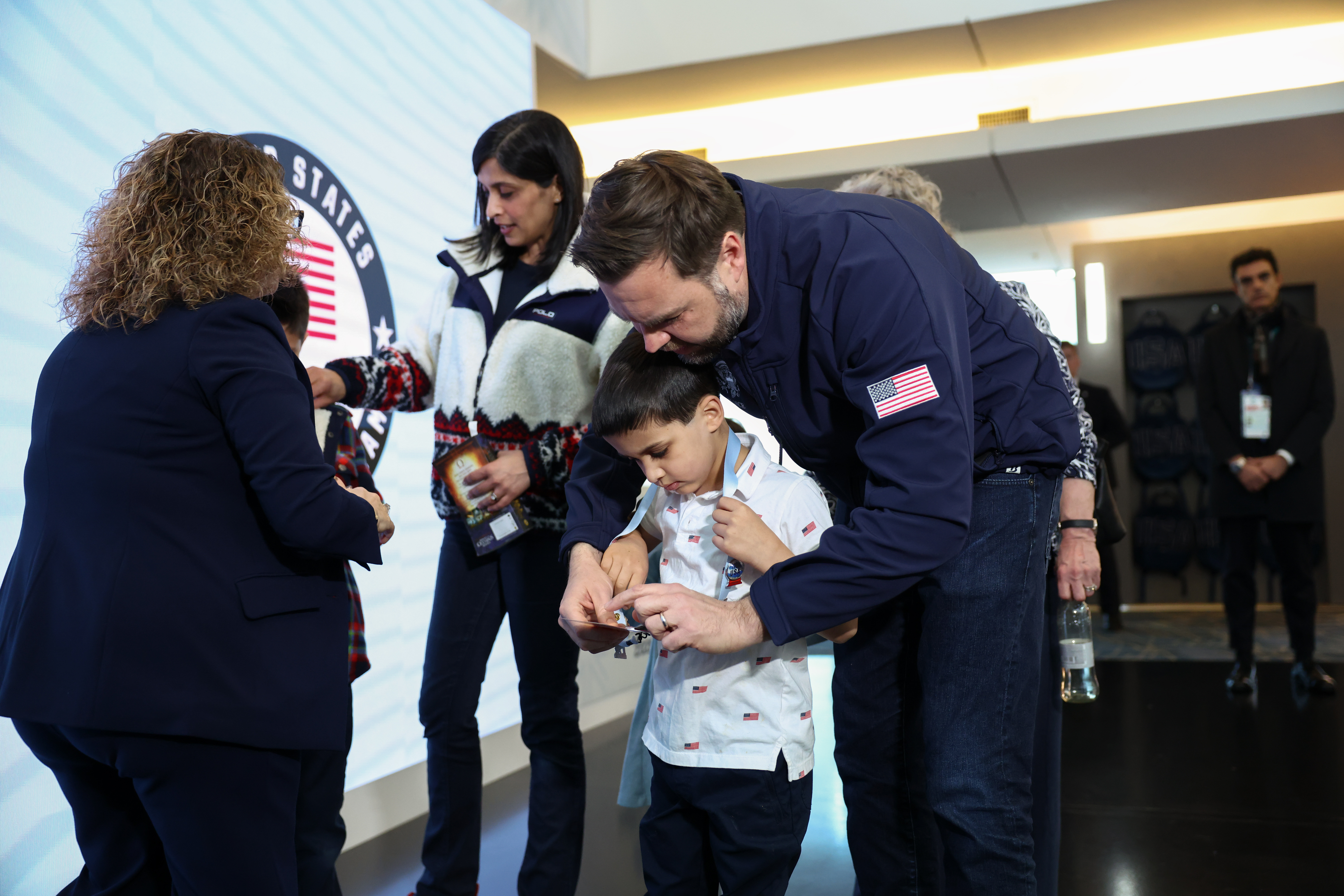 Vice President JD Vance holds his son Vivek's credentials, at the Team USA Welcome Experience, ahead of the Milano Cortina 2026 Winter Olympics in Milan, Italy, Thursday, Feb. 5, 2026.
