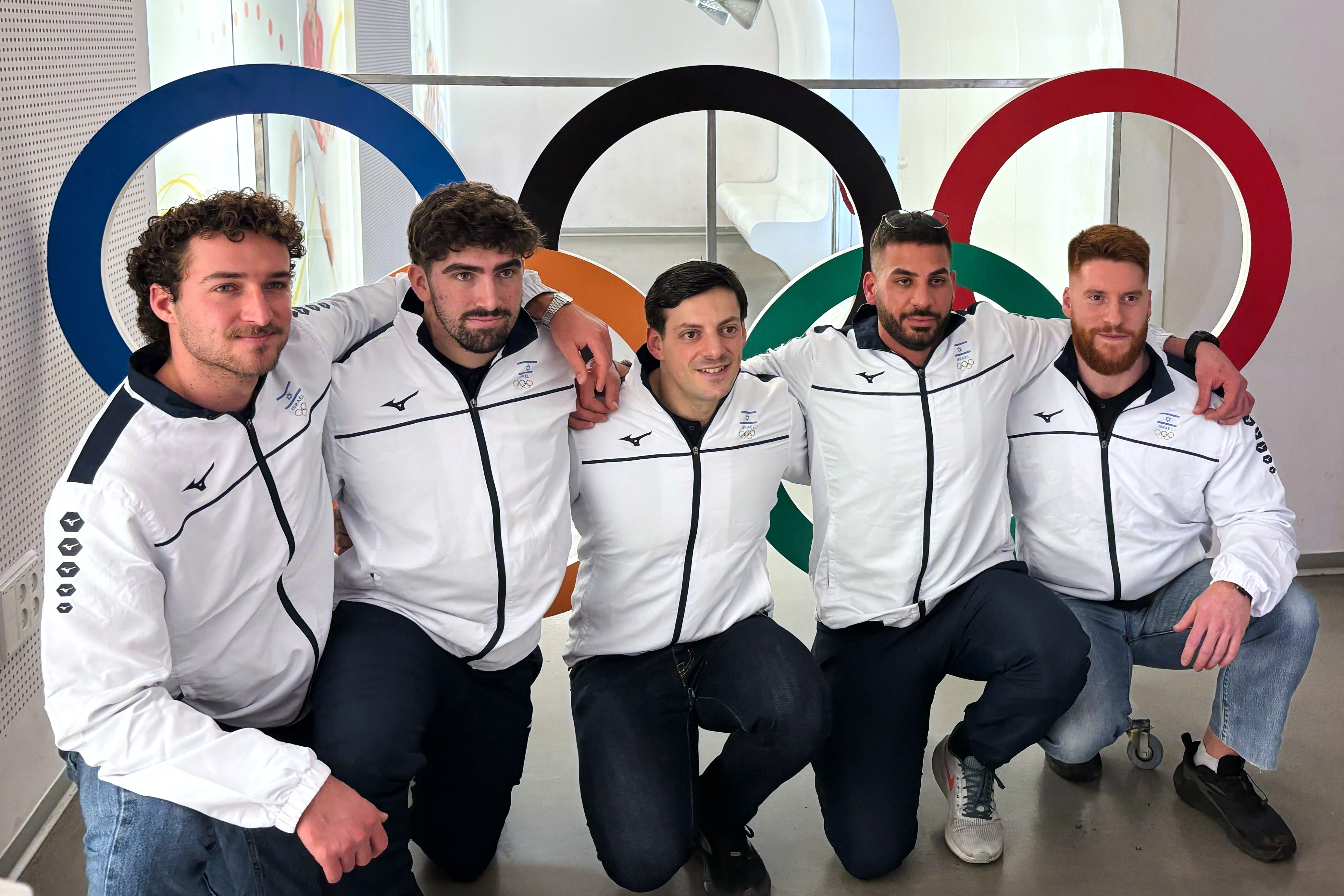 Members of Israel's bobsledding team, from left, Uri Zisman, Omer Katz, AJ Edelman, Ward Farwaseh, Itamar Shprinz, pose at the Israel Olympic Committee headquarters, Wednesday, Jan. 28, 2026, in Tel Aviv, Israel, before their departure for the 2026 Winter Olympics.
