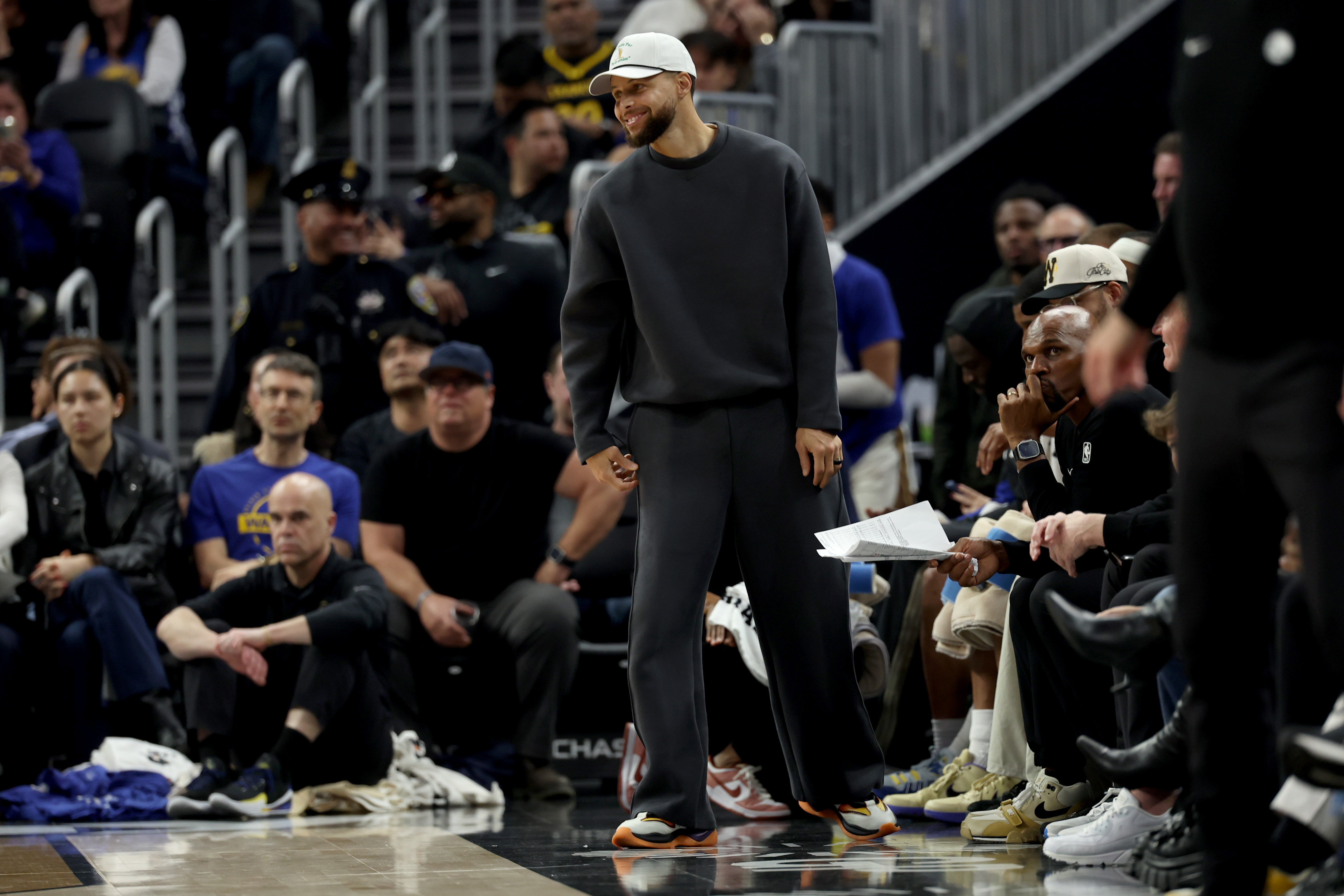 Golden State Warriors guard Stephen Curry stands at the bench during the first half of an NBA basketball game against the Memphis Grizzlies in San Francisco, Monday, Feb. 9, 2026.