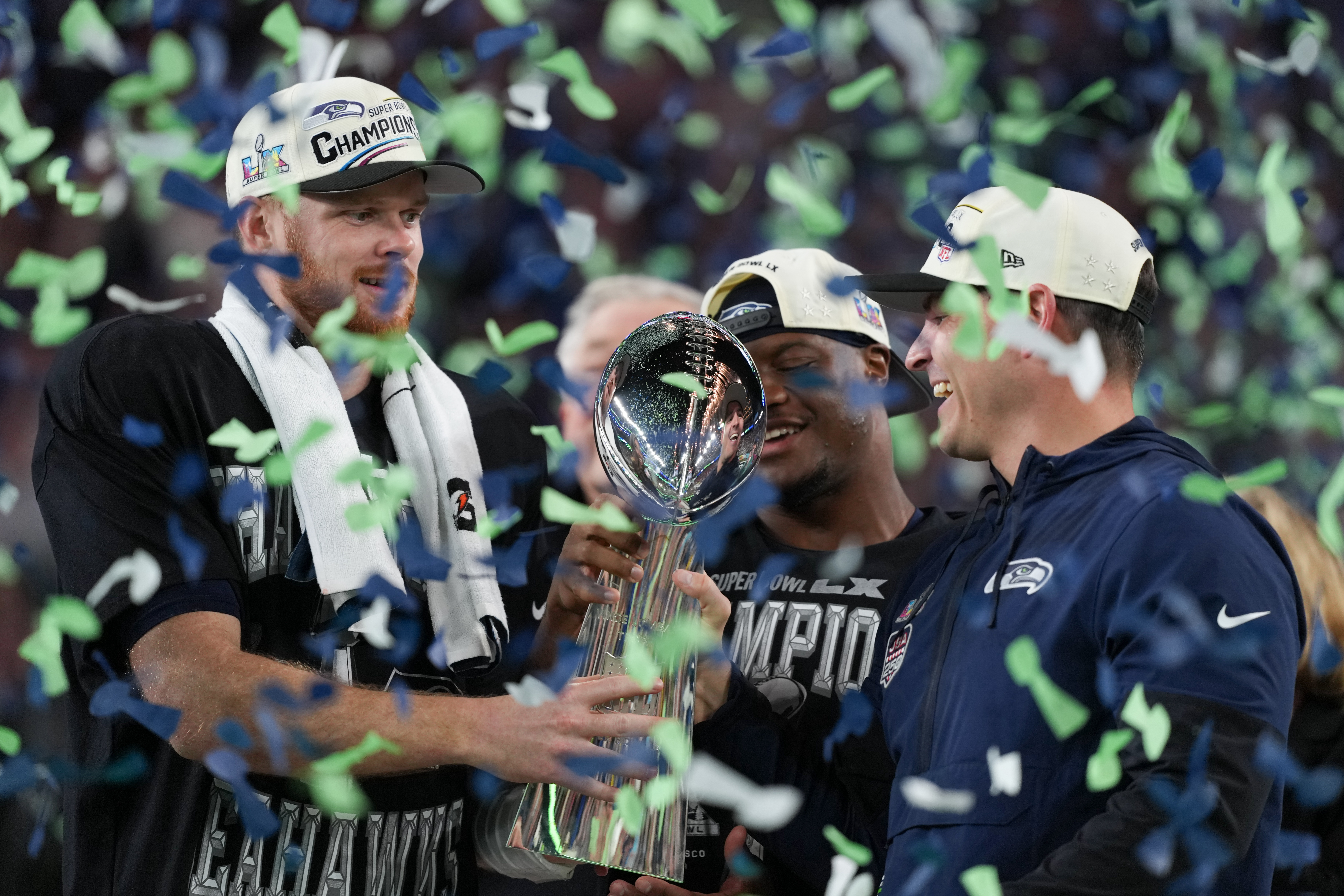 Seattle Seahawks head coach Mike Macdonald and quarterback Sam Darnold, left, hold the Lombardi Trophy after a win over the New England Patriots in the NFL Super Bowl 60 football game Sunday, Feb. 8, 2026, in Santa Clara, Calif.
