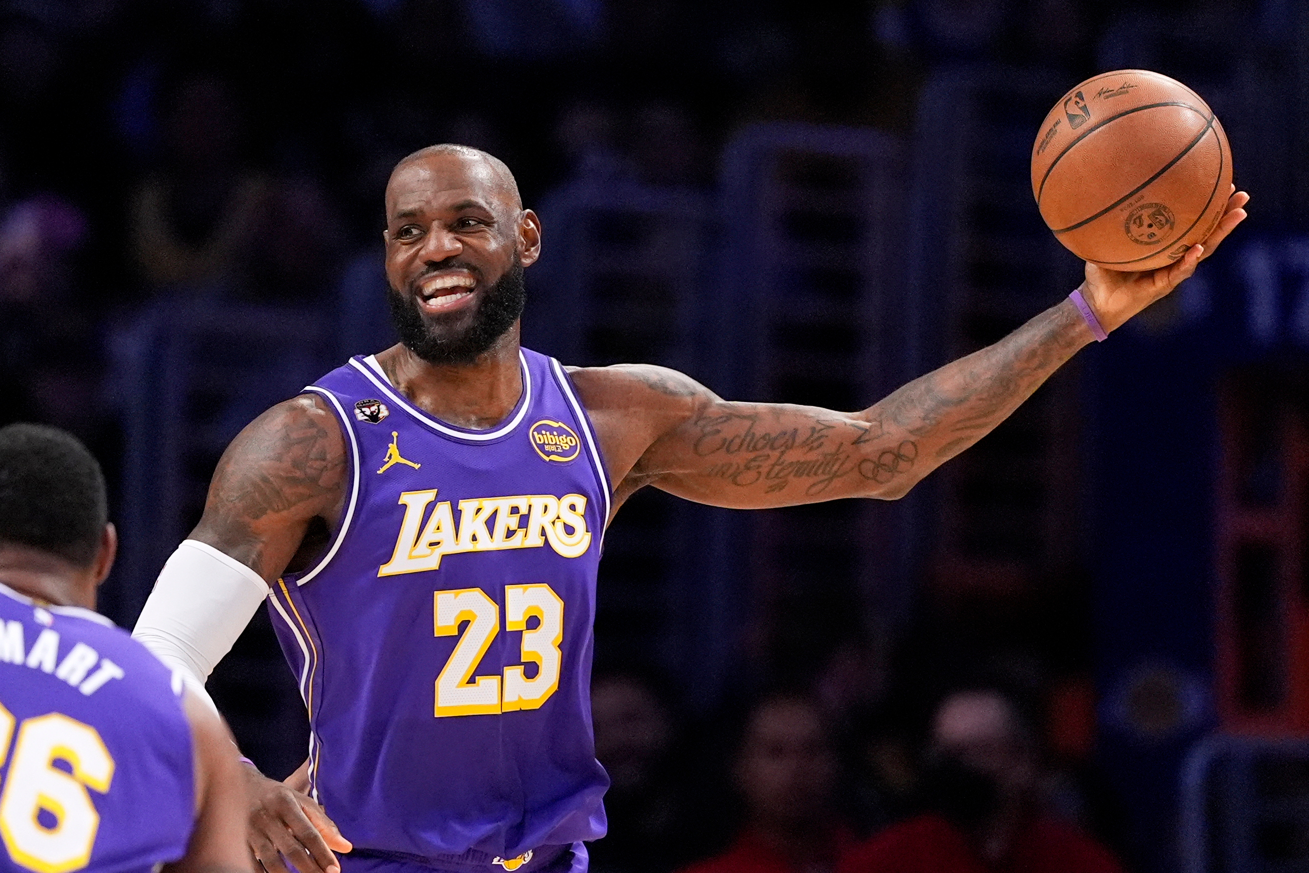 Los Angeles Lakers forward LeBron James smiles as he tries to pass during the first half of an NBA basketball game against the Dallas Mavericks, Thursday, Feb. 12, 2026, in Los Angeles. (AP Photo/Mark J. Terrill)