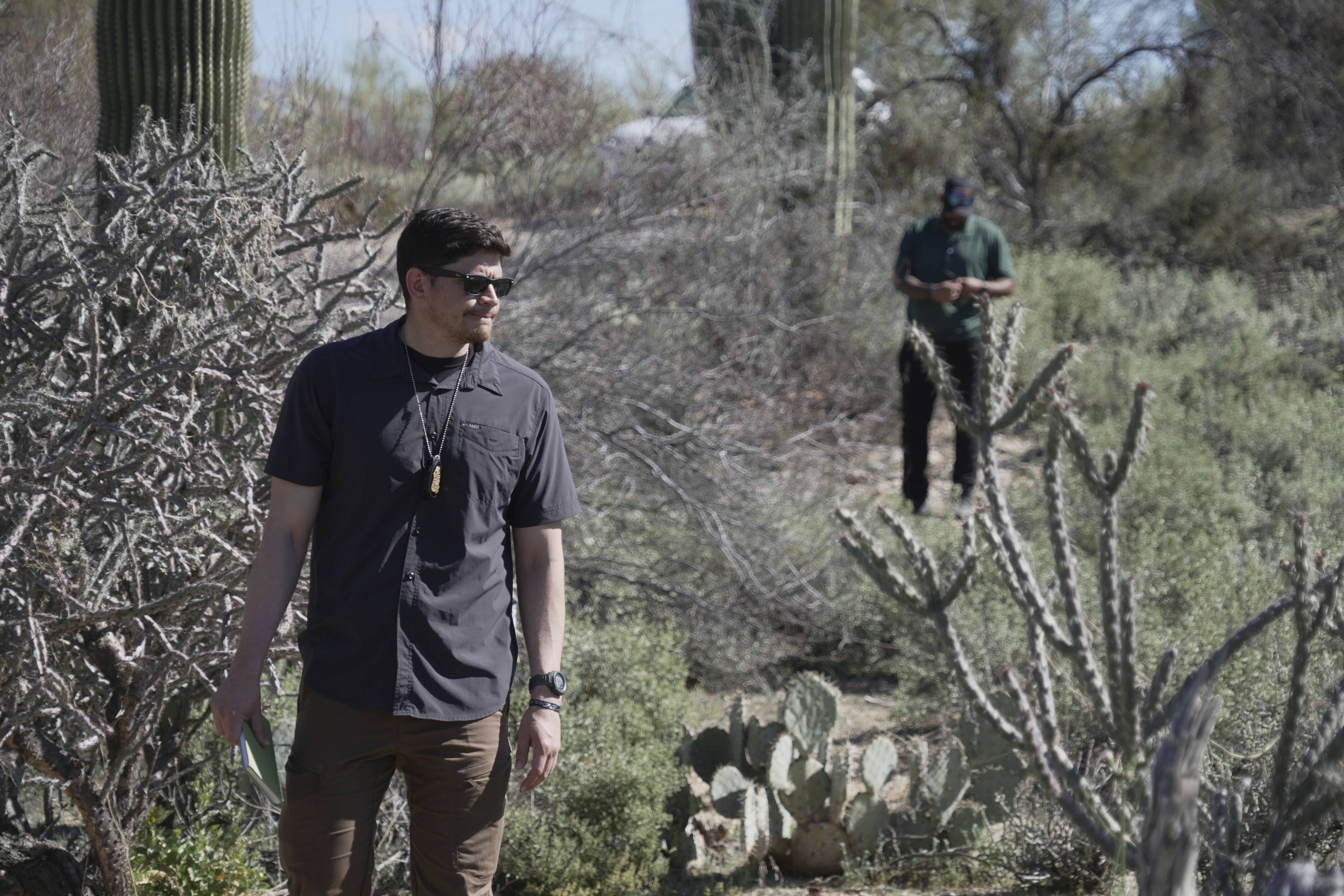 Law enforcement agents comb a desert terrain in the search for missing Nancy Guthrie in a Tucson-area neighborhood. 