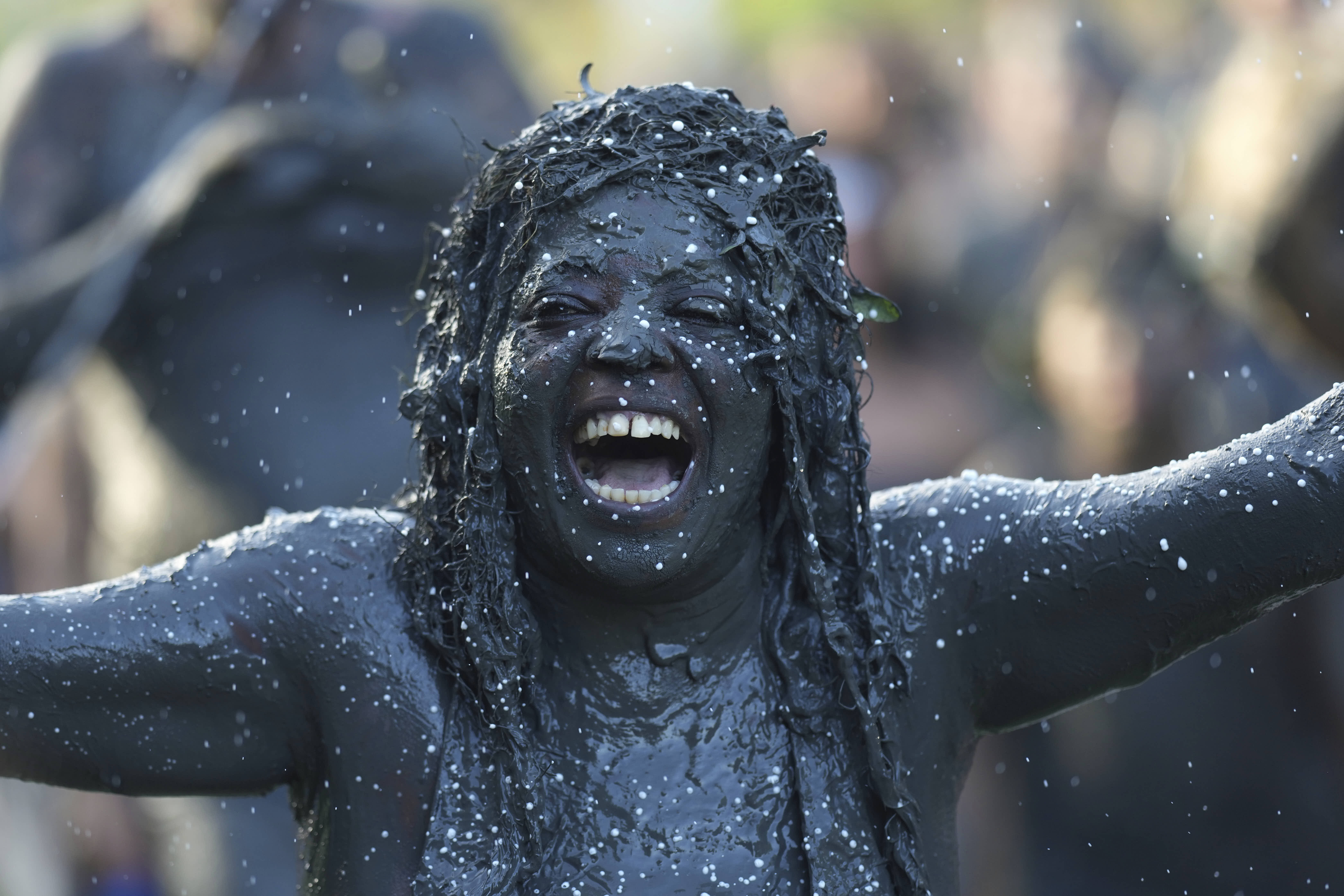  reveler celebrates during the Mud Block carnival party in Paraty.