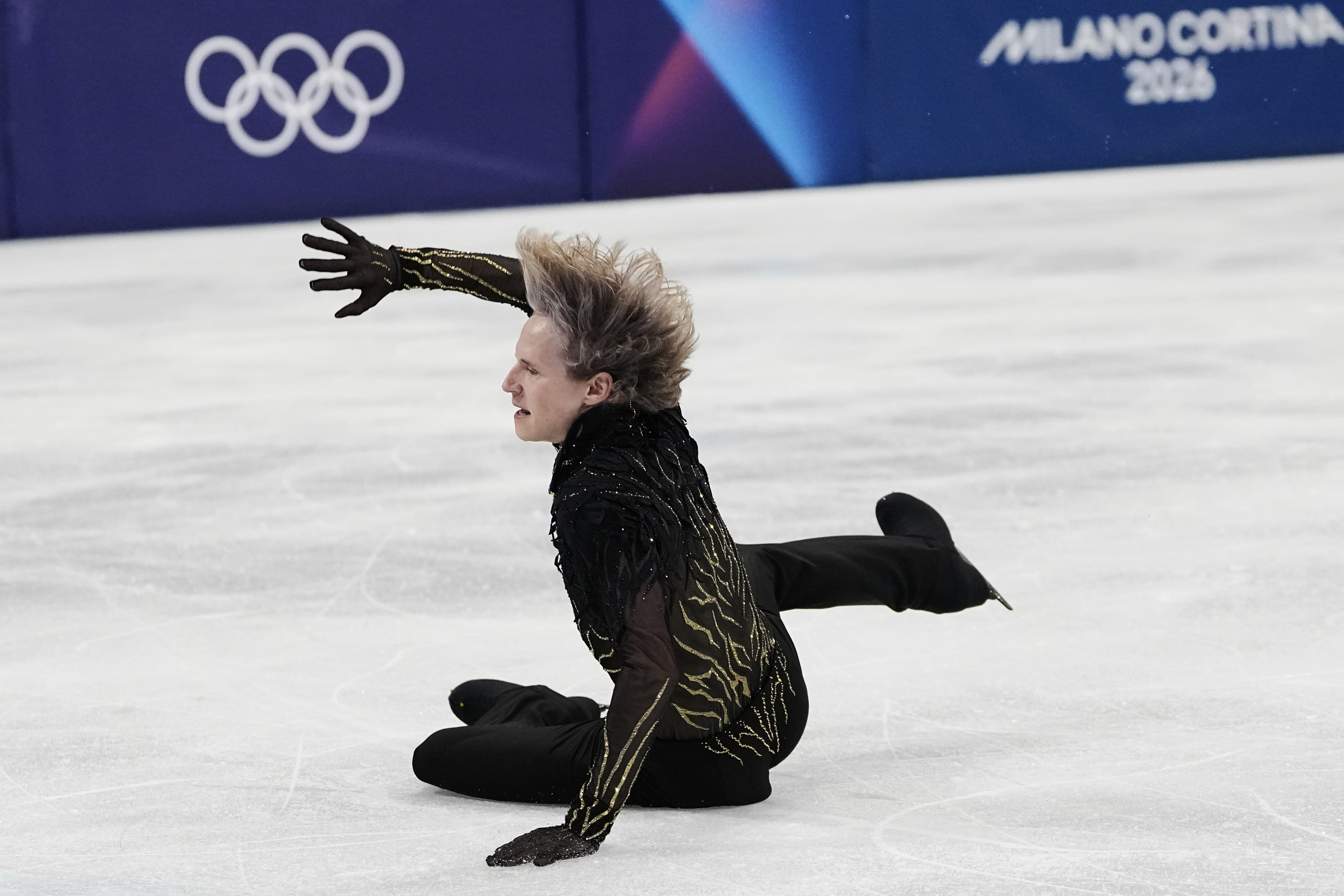American Ilia Malinin falls during his free skate program at the Winter Olympics in Milan.