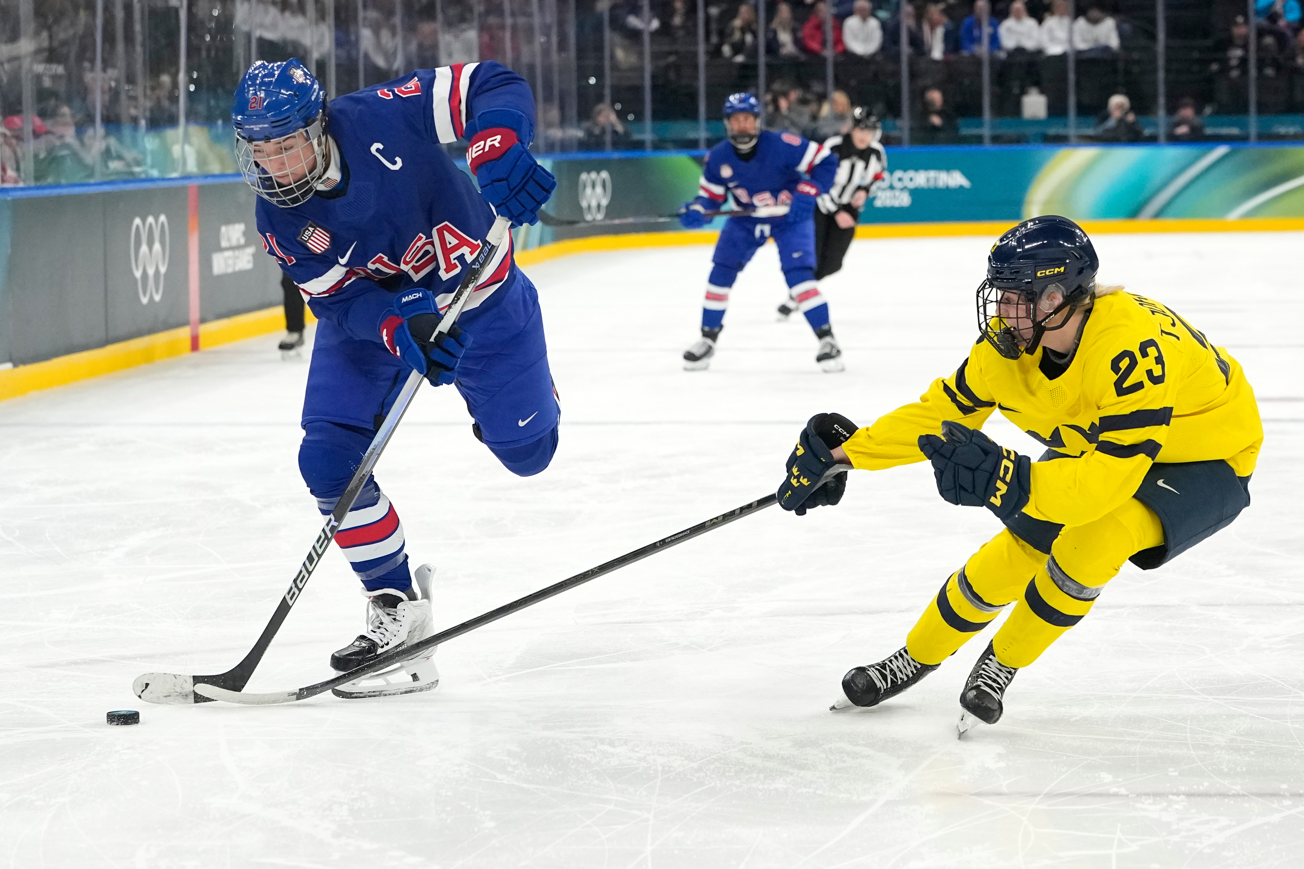 United States' Hilary Knight (21) challenges with Sweden's Thea Johansson (23) during a women's ice hockey semifinal game between the United States and Sweden at the 2026 Winter Olympics, in Milan, Italy, Monday, Feb. 16, 2026.