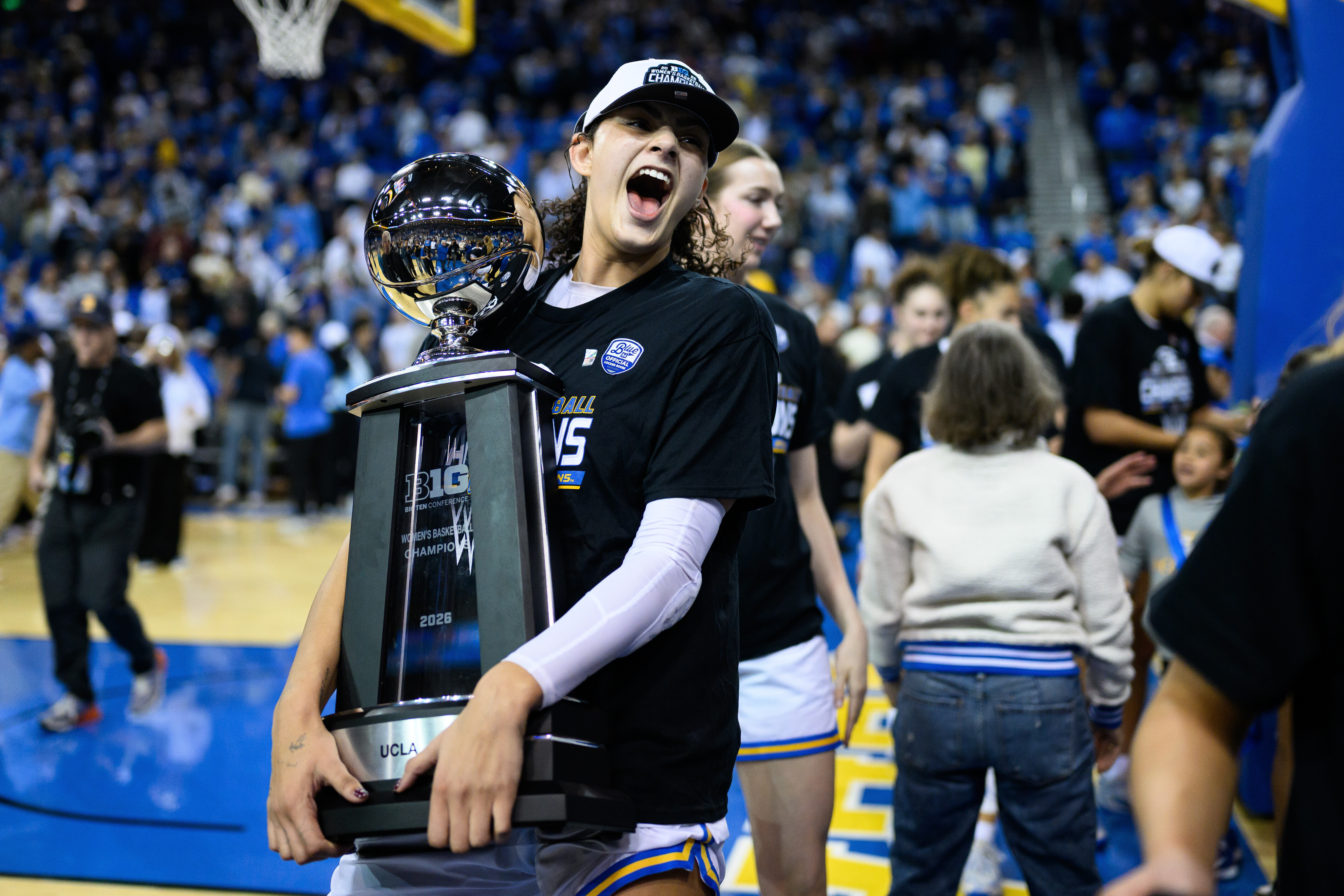 UCLA center Lauren Betts carries the Big Ten trophy after an NCAA college basketball game against Wisconsin, Sunday, Feb. 22, 2026, in Los Angeles.