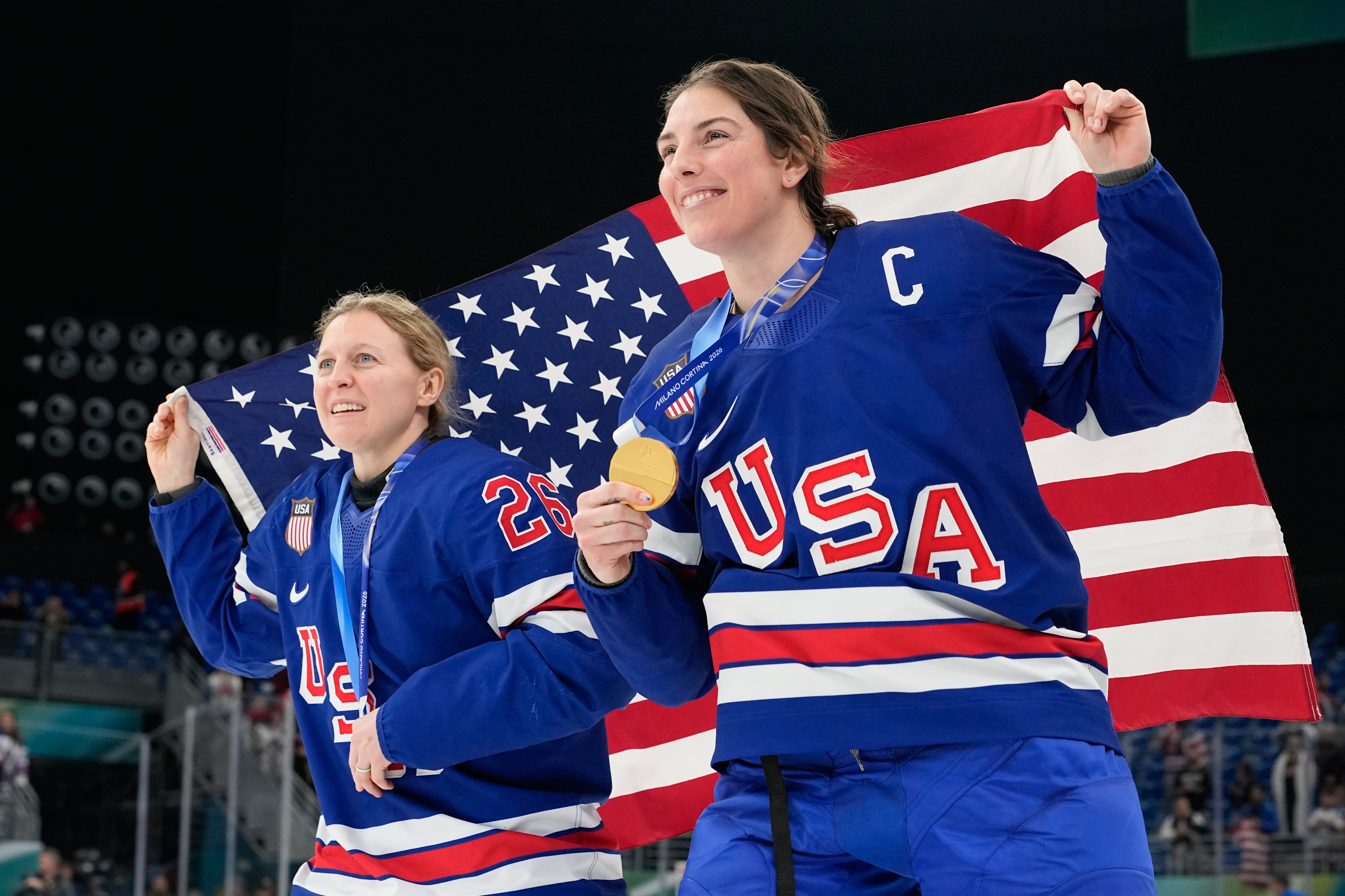 United States' Kendall Coyne, left, and United States' Hilary Knight celebrate after victory ceremony for women's ice hockey at the 2026 Winter Olympics, in Milan, Italy, Thursday, Feb. 19, 2026.