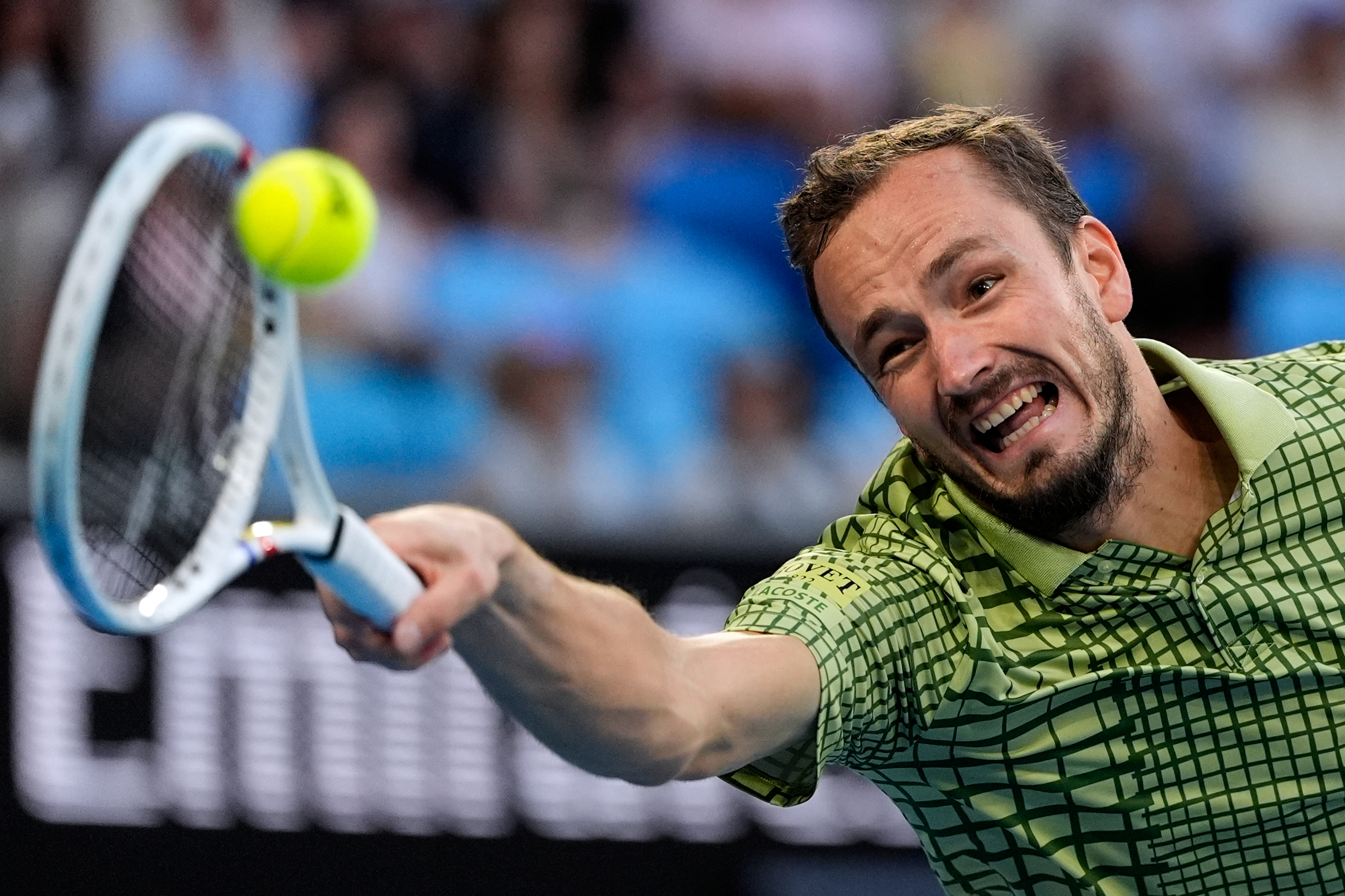 FILE - Daniil Medvedev of Russia plays a forehand return to Learner Tien of the U.S. during their fourth round match at the Australian Open tennis championship in Melbourne, Australia, Jan. 25, 2026.
