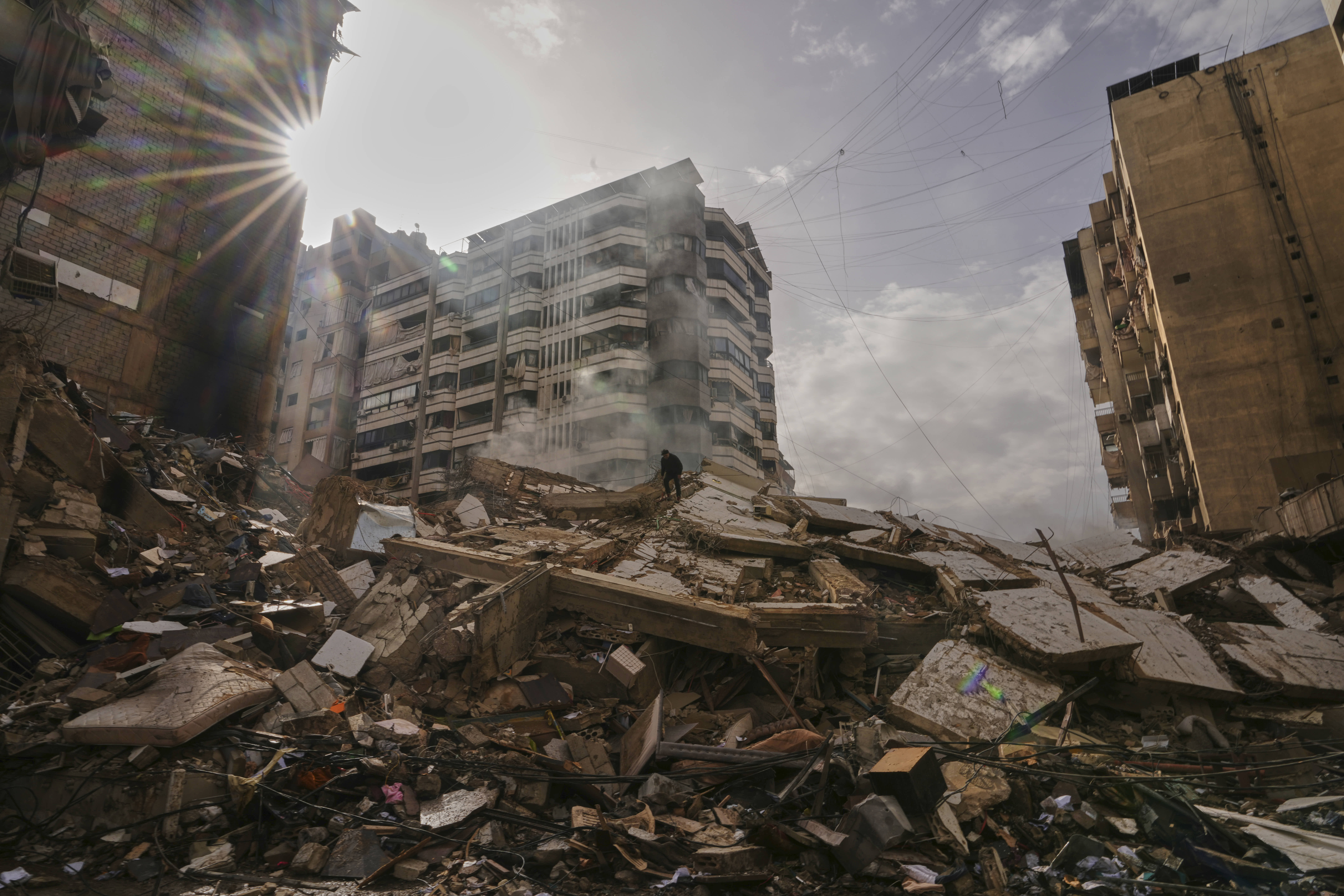 A man walks on a pile of rubble after an Israeli airstrike in Lebanon.