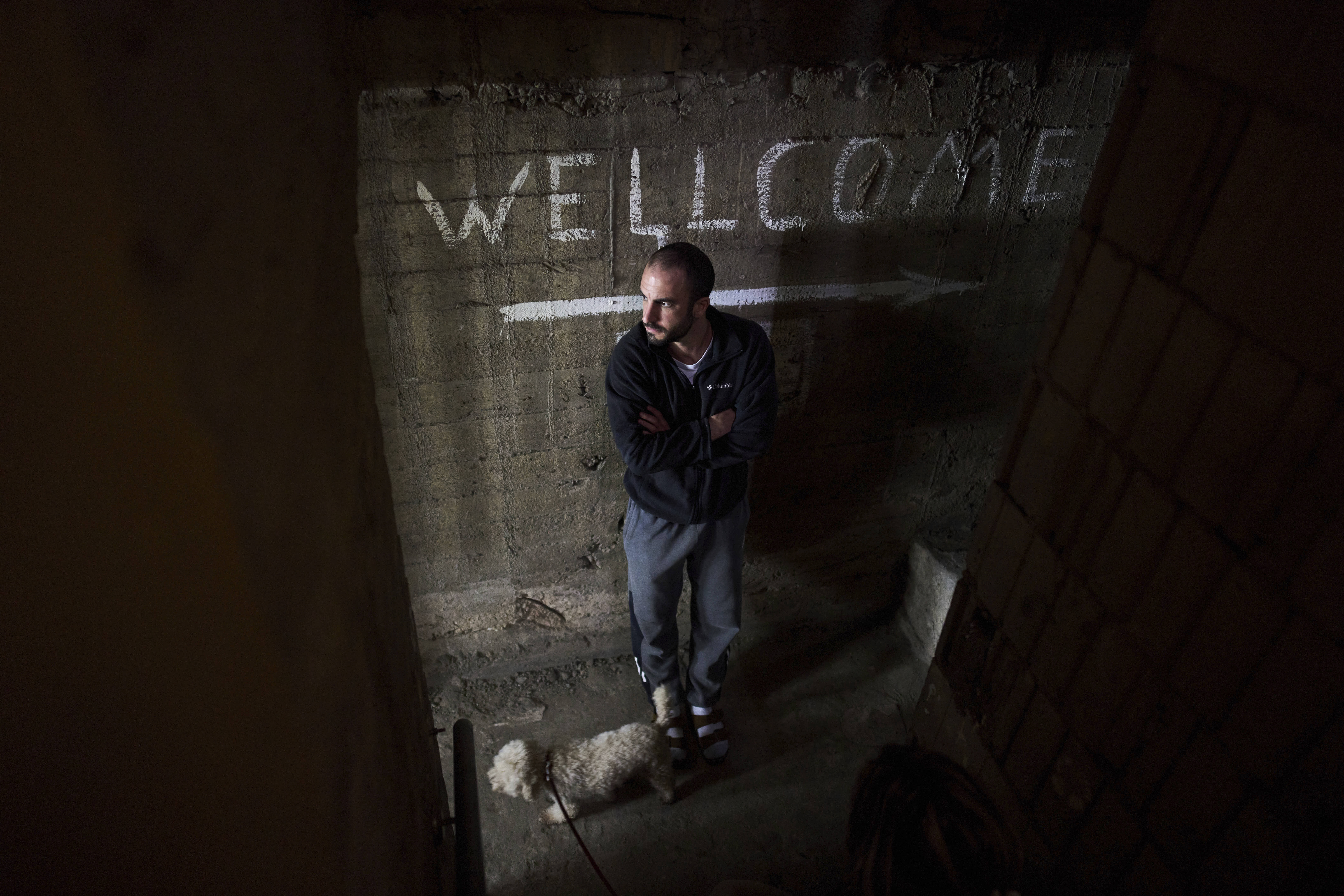 A man takes cover in a bomb shelter in Israel as air raid sirens warn of incoming Iranian missile strikes.