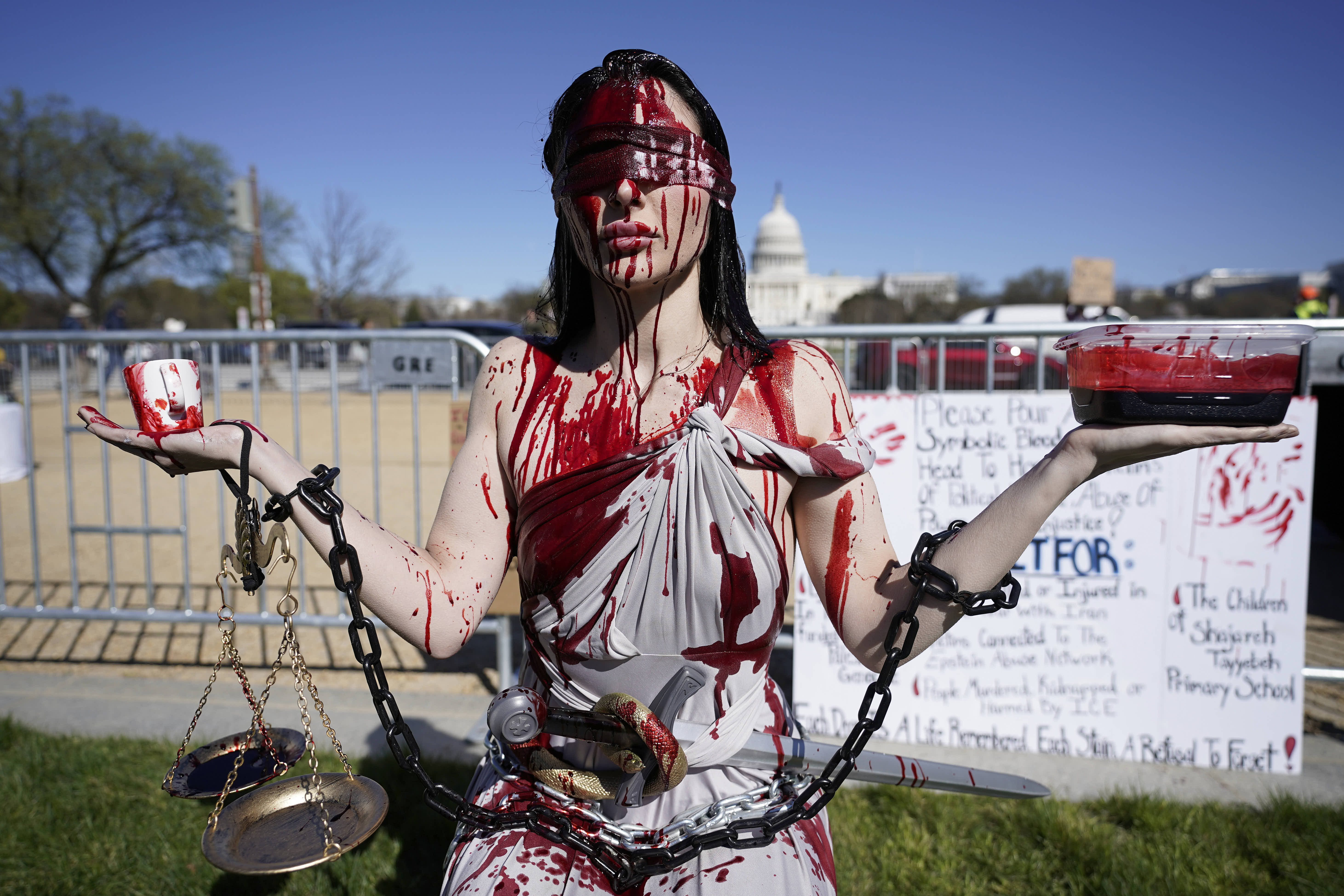 A demonstrator, dressed as Lady Justice attends a ‘No Kings’ protest rally in Washington.