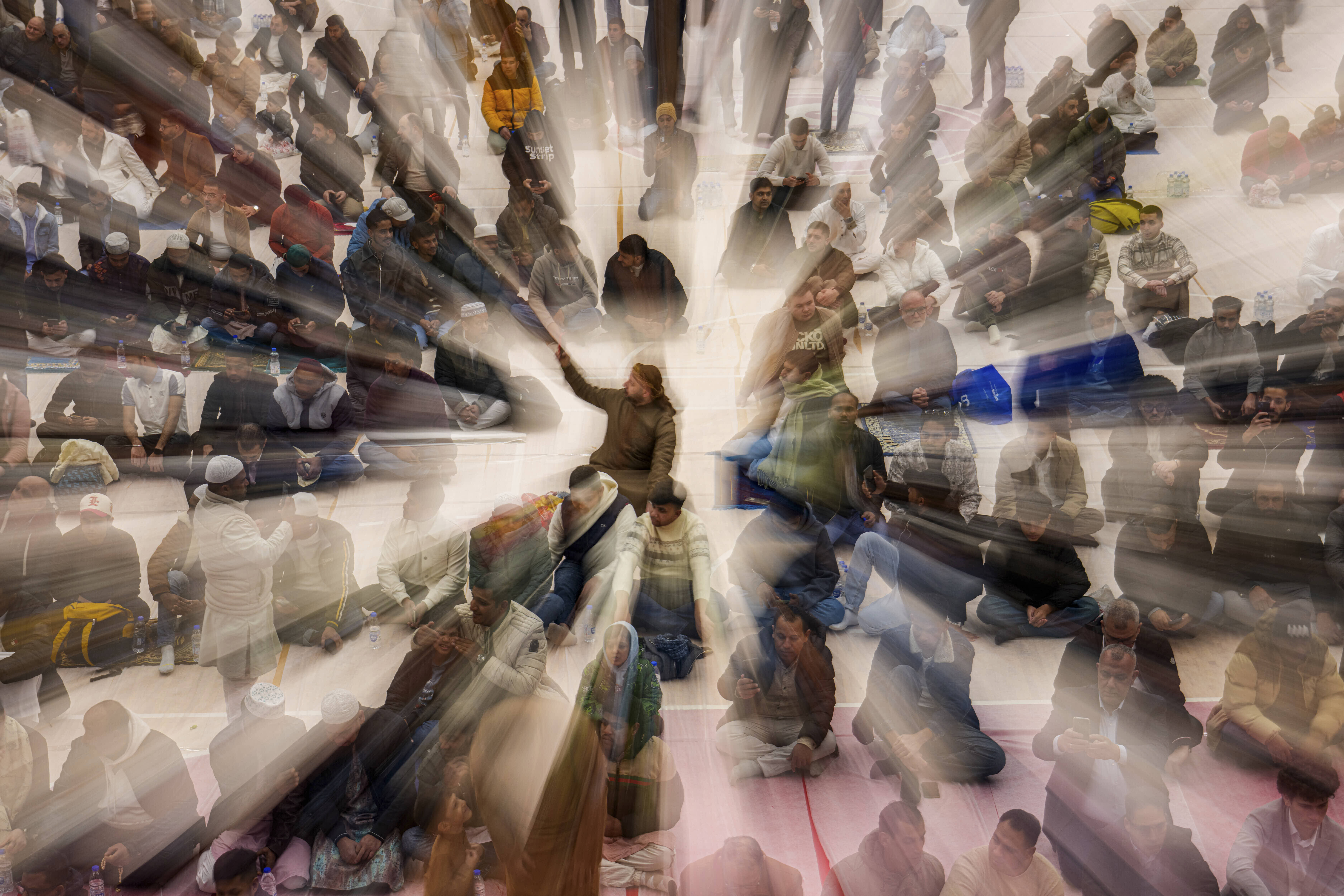 Muslims wait before Eid al-Fitr prayers in a sports hall in Bucharest, Romania. 