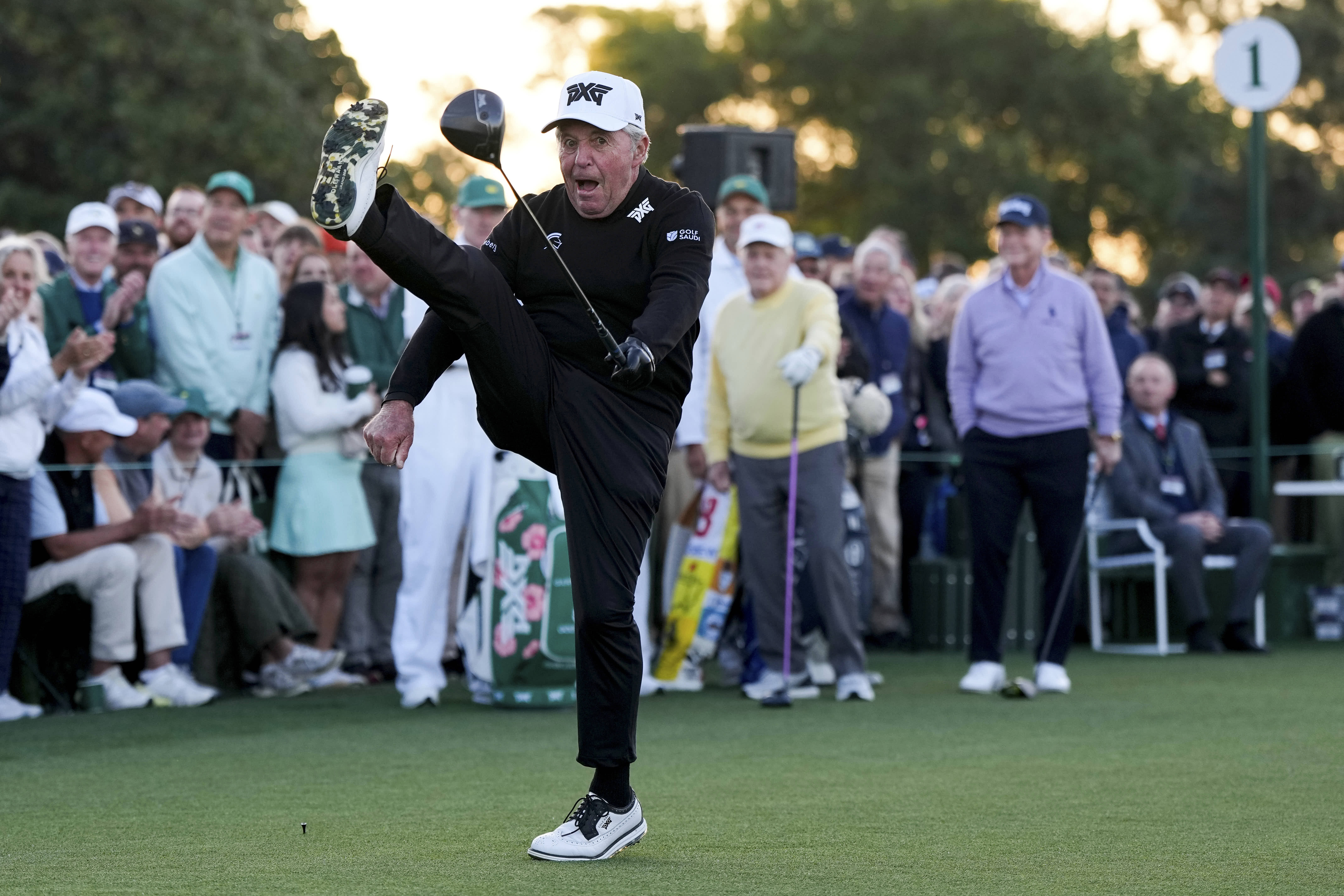 Gary Player kicks his leg in the air after hitting the ceremonial tee shot at the Masters golf tournament in Augusta, Ga.