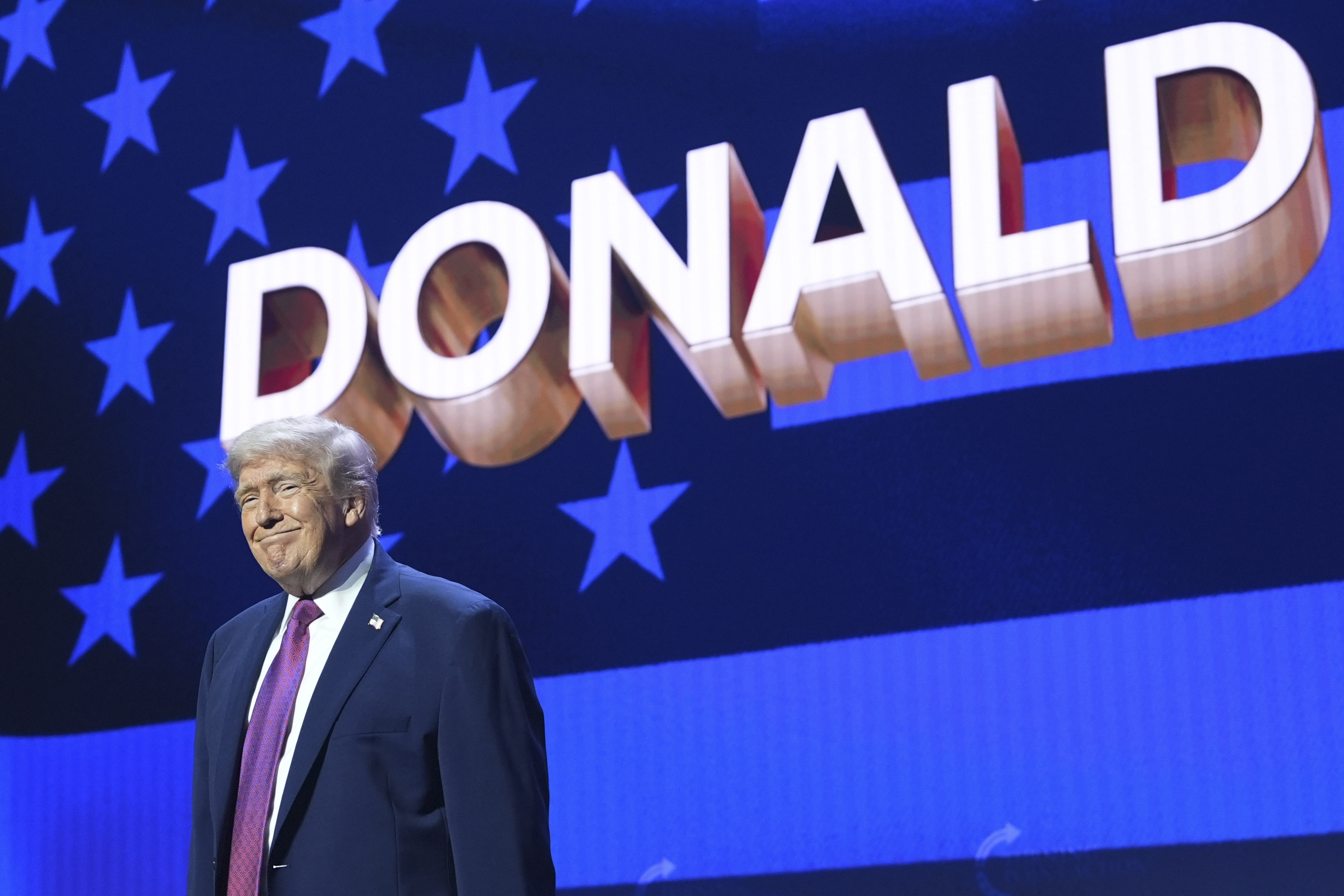President Donald Trump takes the stage during a Turning Point USA event in Phoenix.