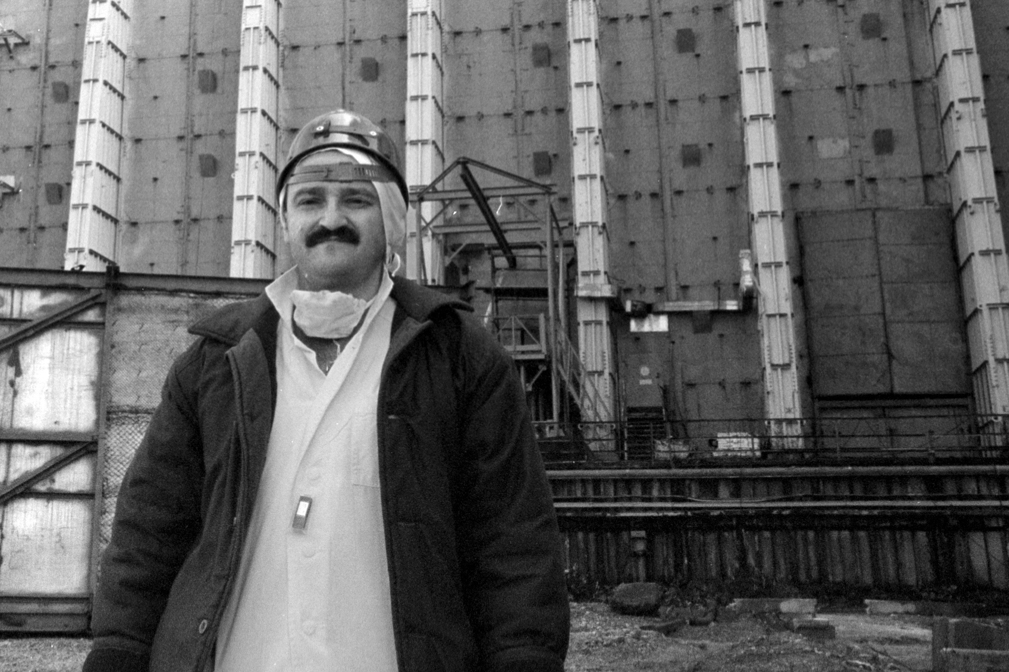 Efrem Lukatsky stands outside the destroyed Reactor No. 4 at the Chernobyl nuclear power plant.