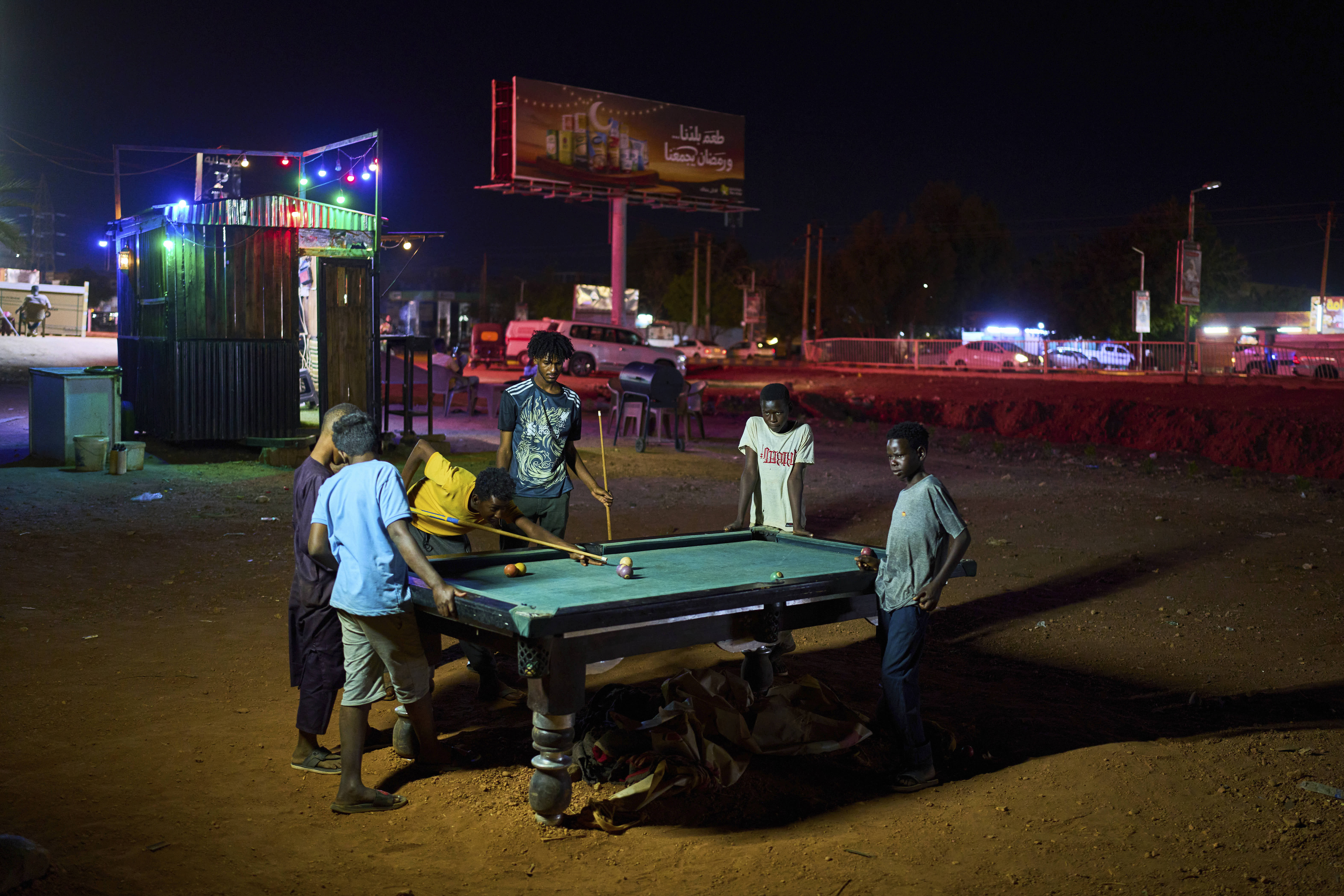 Children play billiards in an outdoor lot in Omdurman, Sudan.