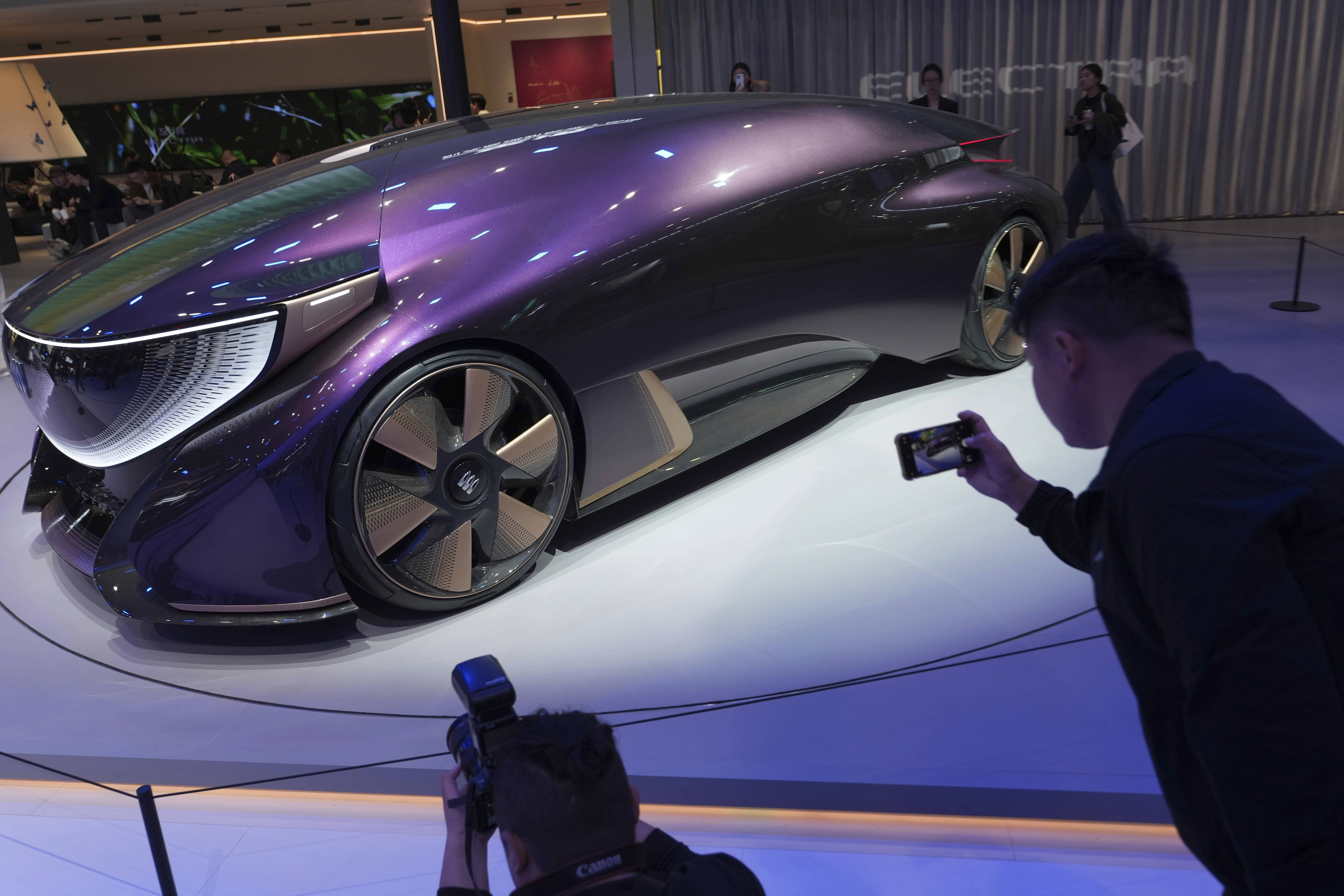 Attendees photograph a Buick concept vehicle at the Beijing auto show. 