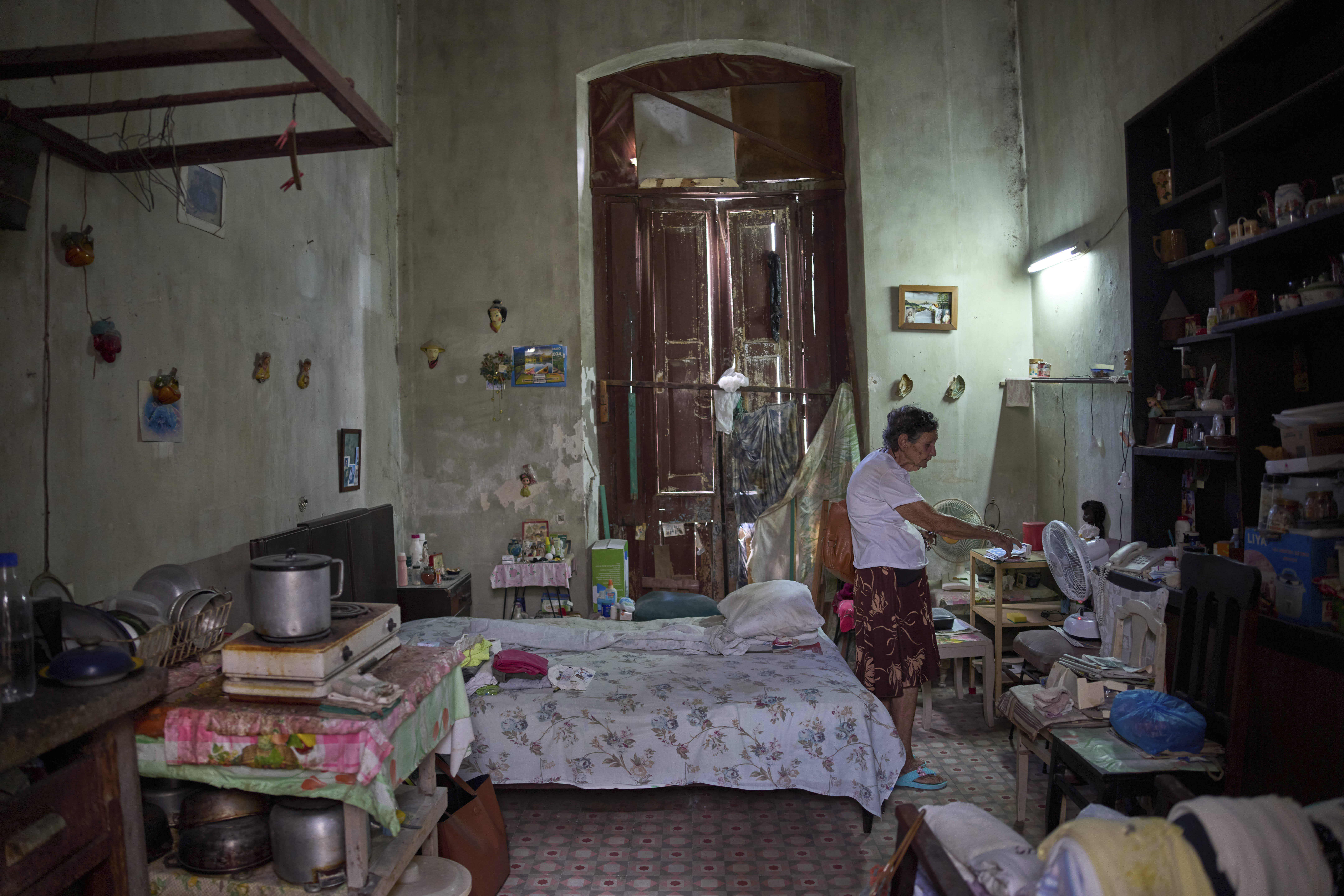 Mercedes Lopez Rey stands in her one-room apartment in Old Havana, Cuba.