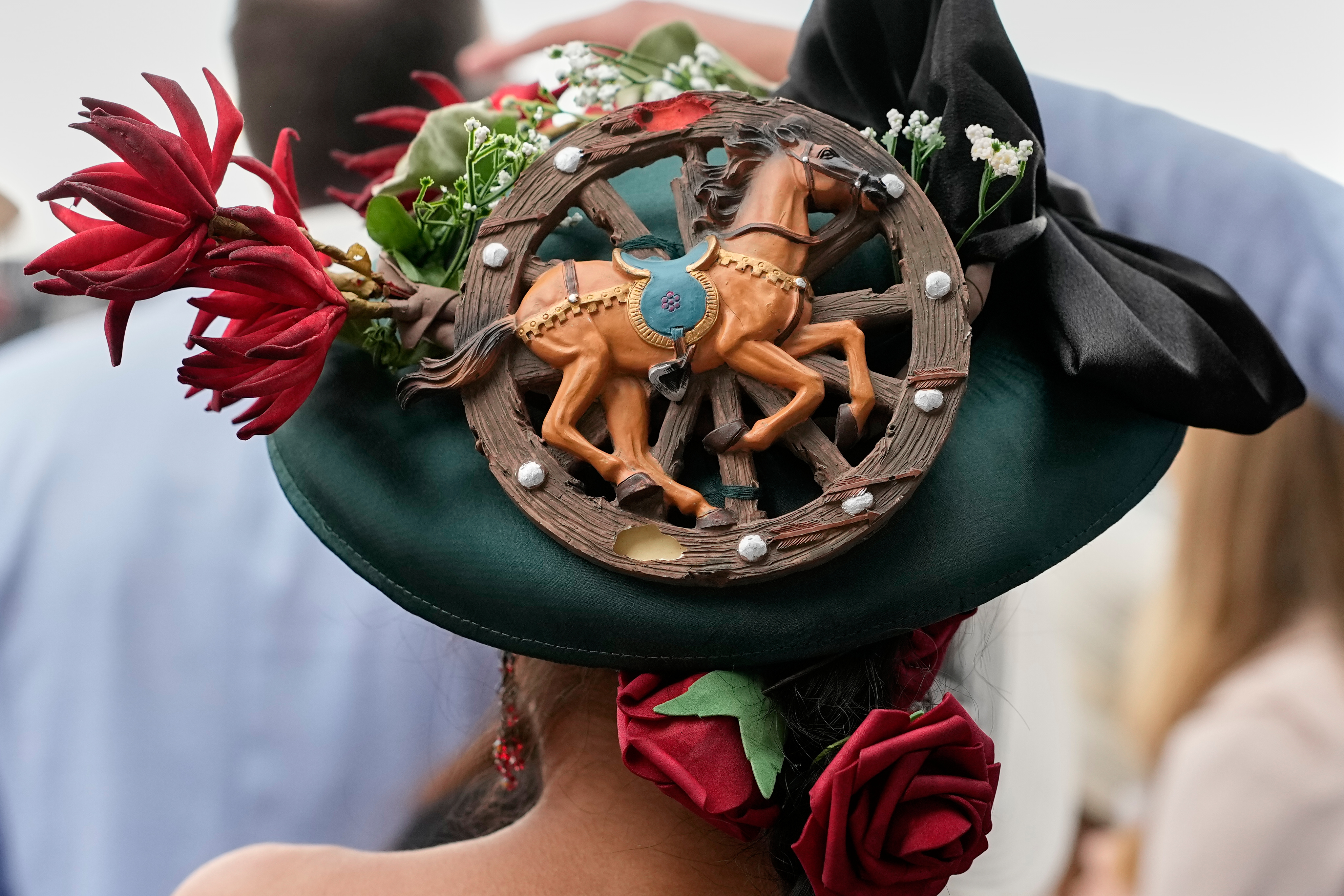 A woman in a horse-themed hat attends the 152nd running of the Kentucky Derby at Churchill Downs in Louisville, Ky. 