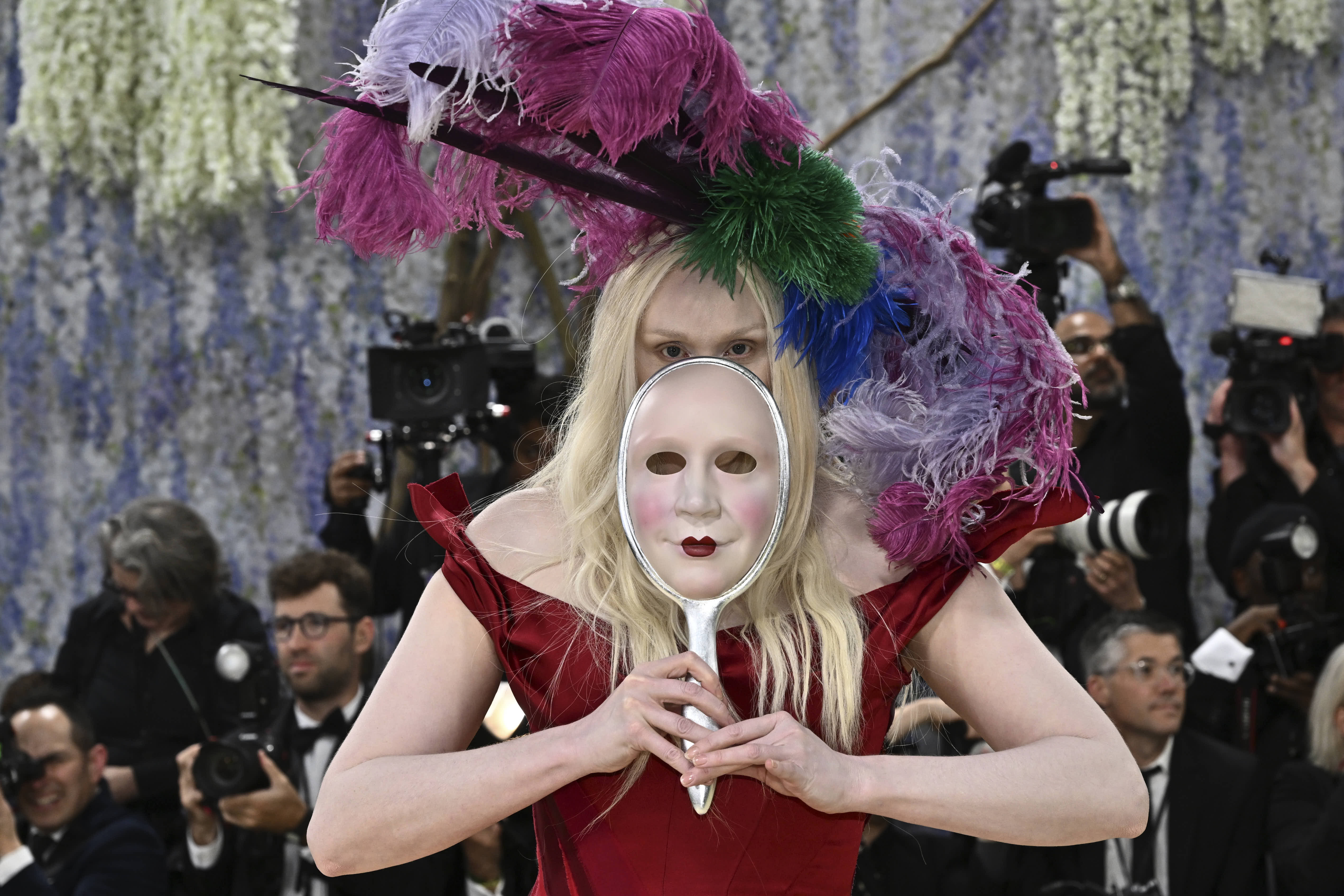 English actress Gwendoline Christie, holding a mask of her own face, arrives at the Met Gala in New York. 