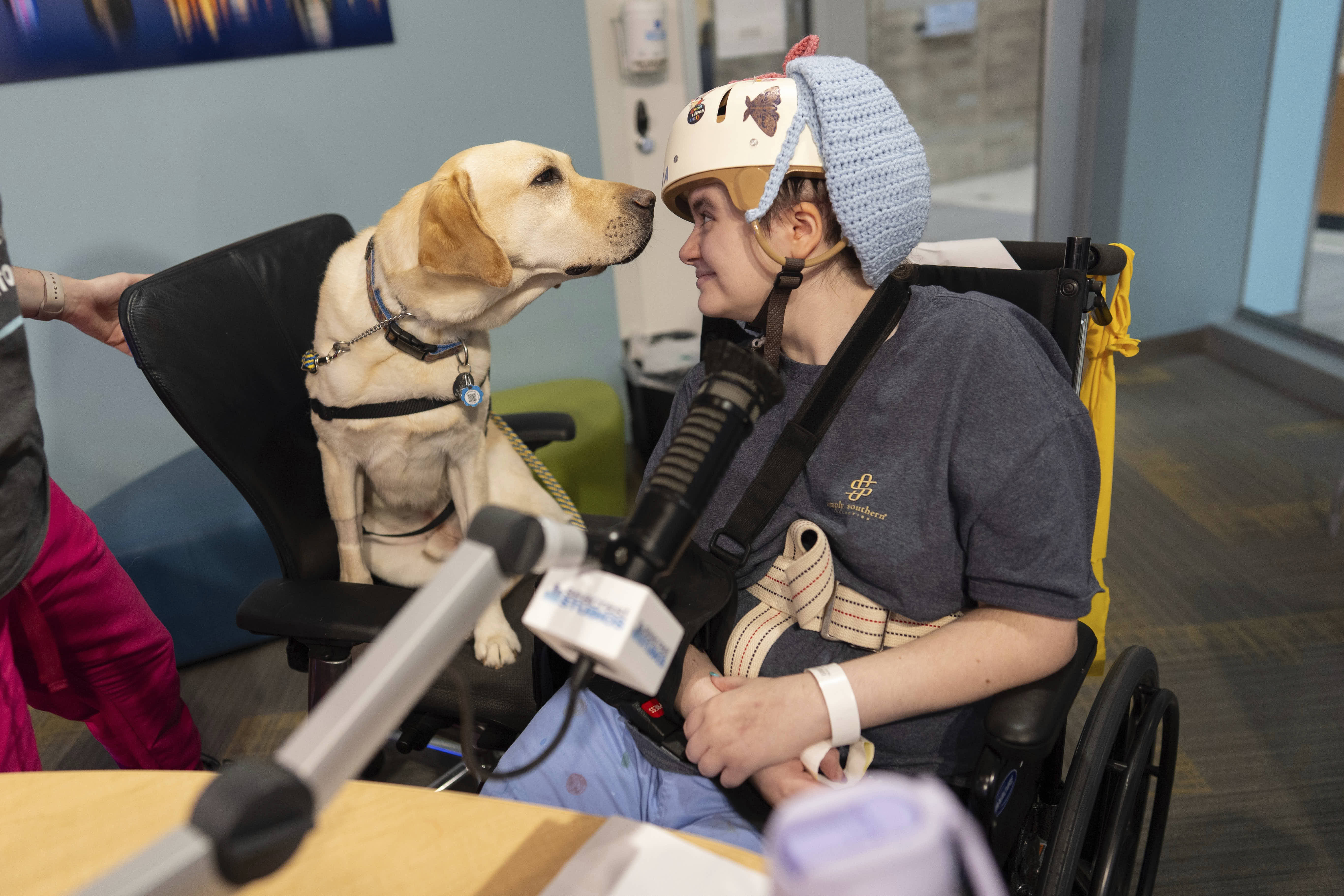 Facility dog Grover looks to patient Kira Hodge at the Children's Hospital in Cincinnati.