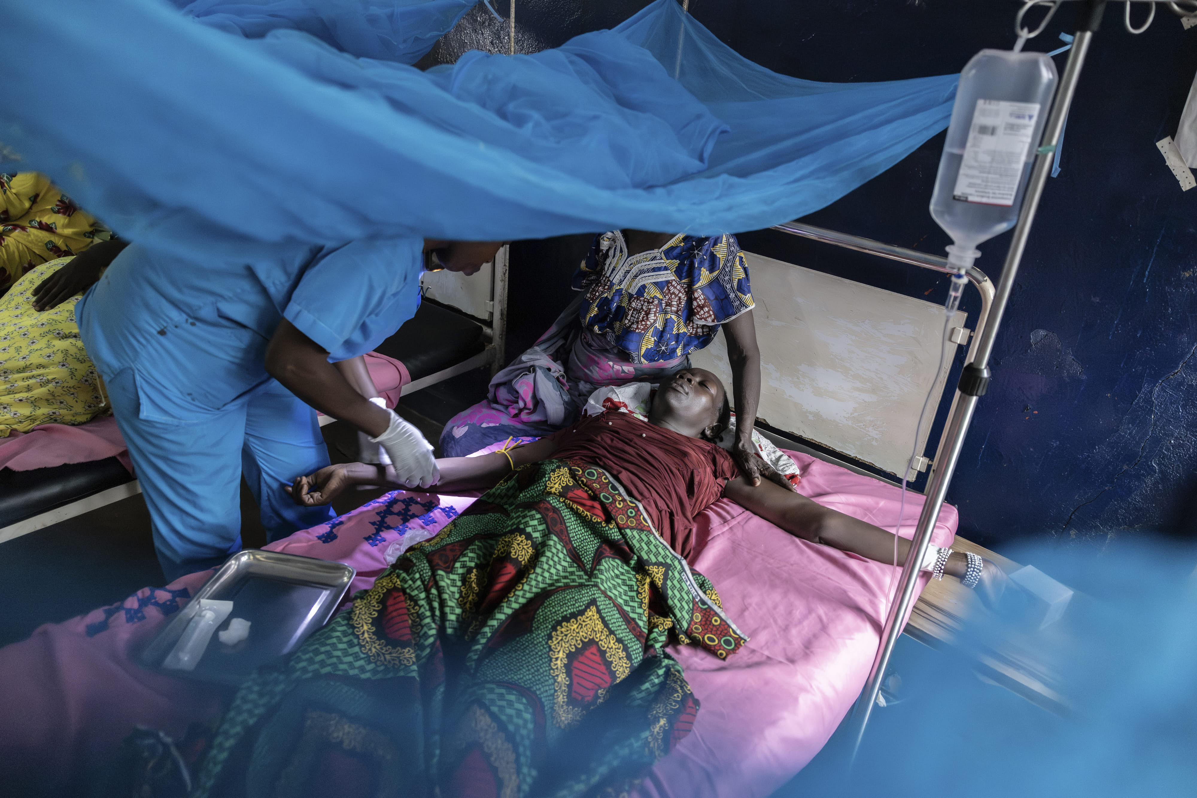 A nurse administers painkillers to Amna Adam Hessen after she delivered a stillborn baby in Central African Republic. 