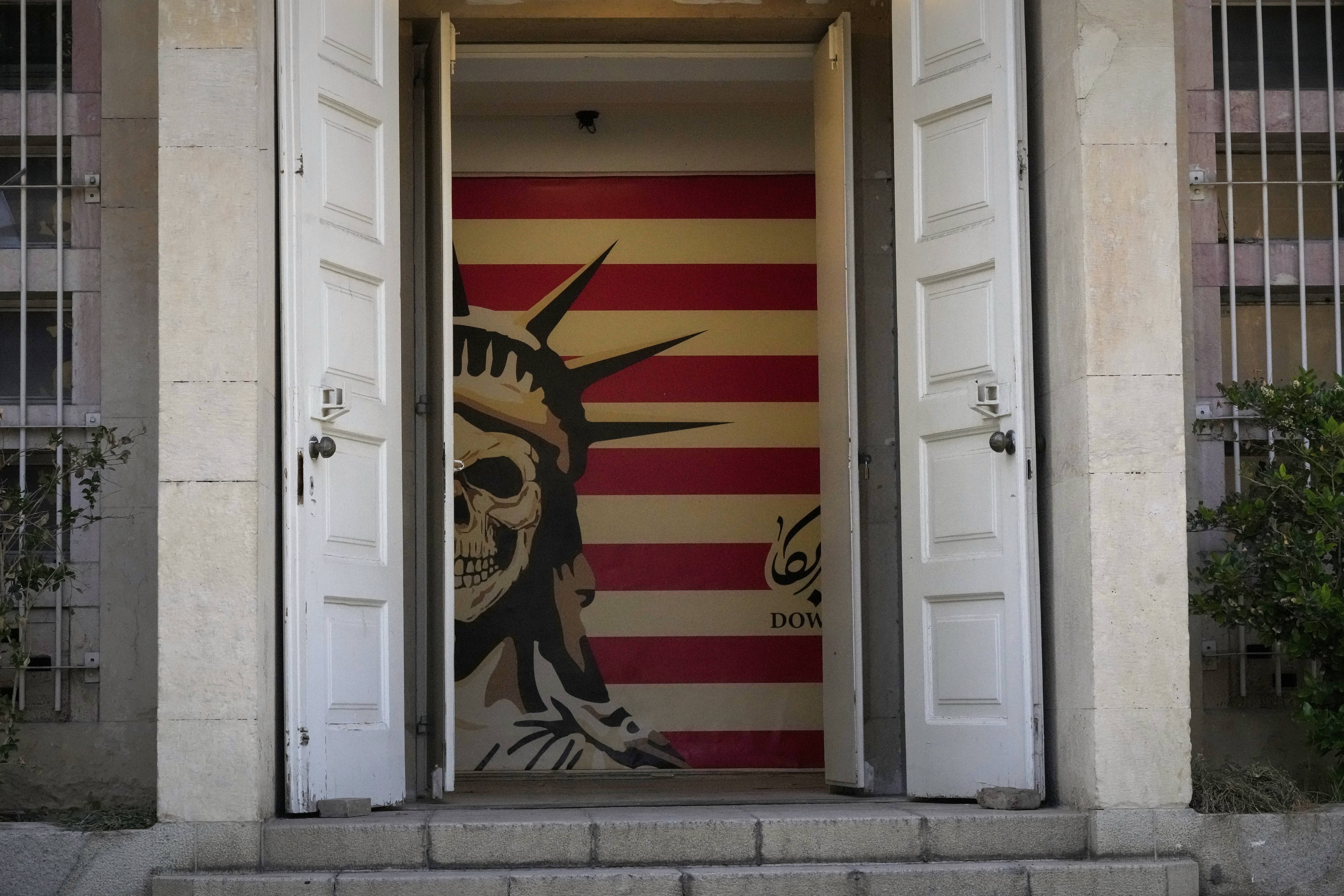 A satirical mural of the Statue of Liberty and the U.S. flag covers an interior wall in the entry hall of the former U.S. Embassy in Tehran. 