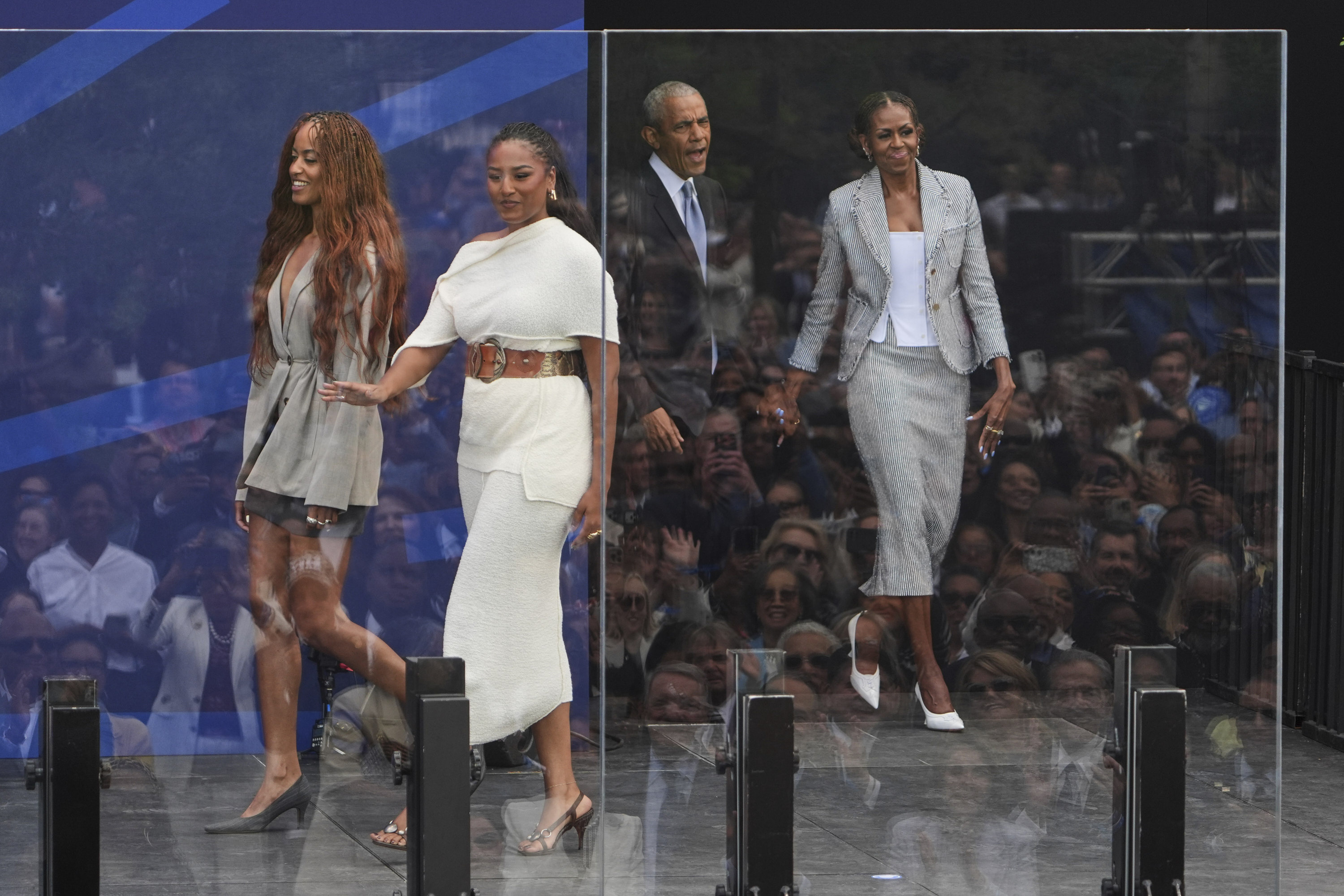 The Obamas take the stage during the dedication ceremony for the Obama Presidential Center in Chicago.