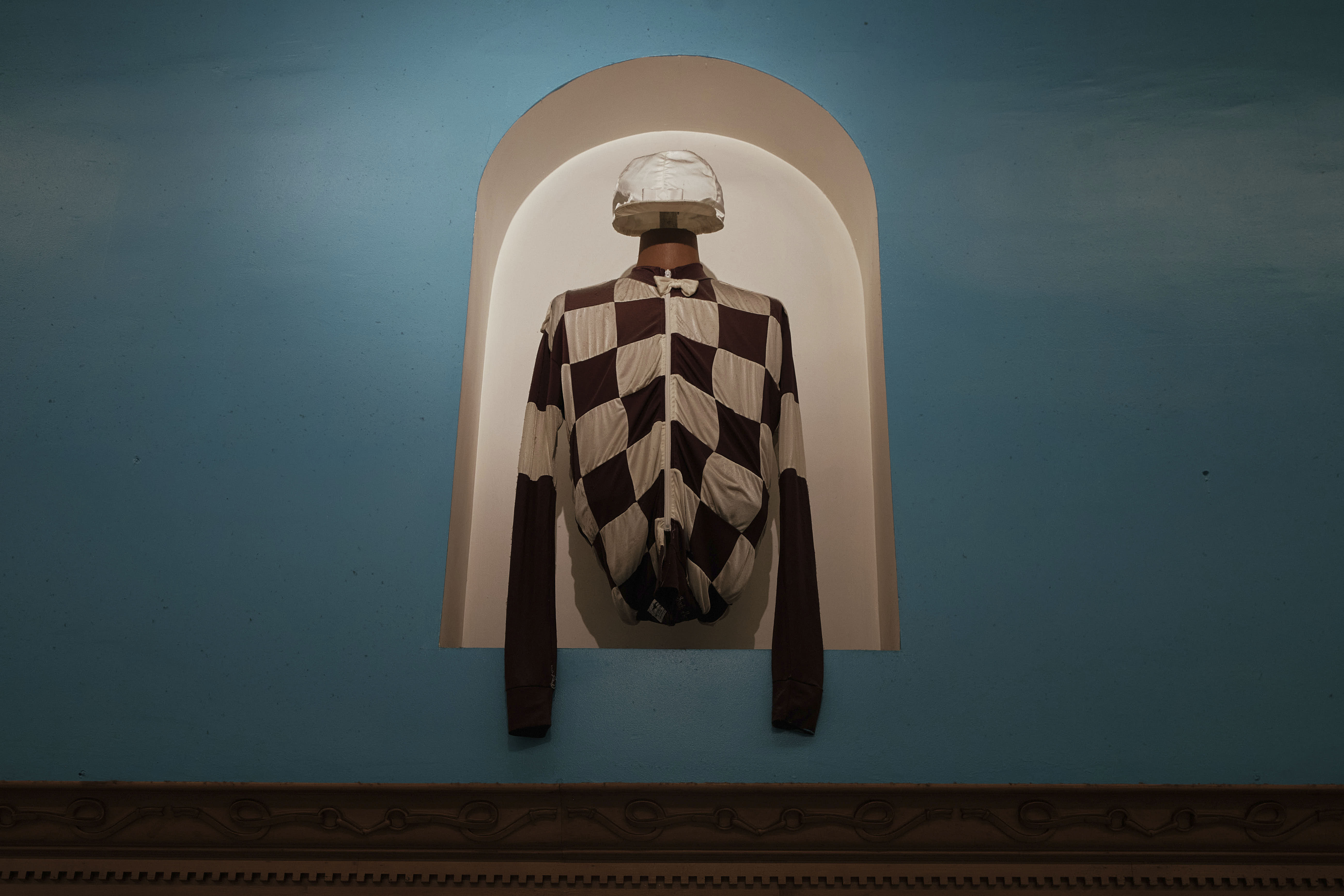 A jockey's silks and helmet cover are on exhibit inside the Aqueduct Racetrack in New York..