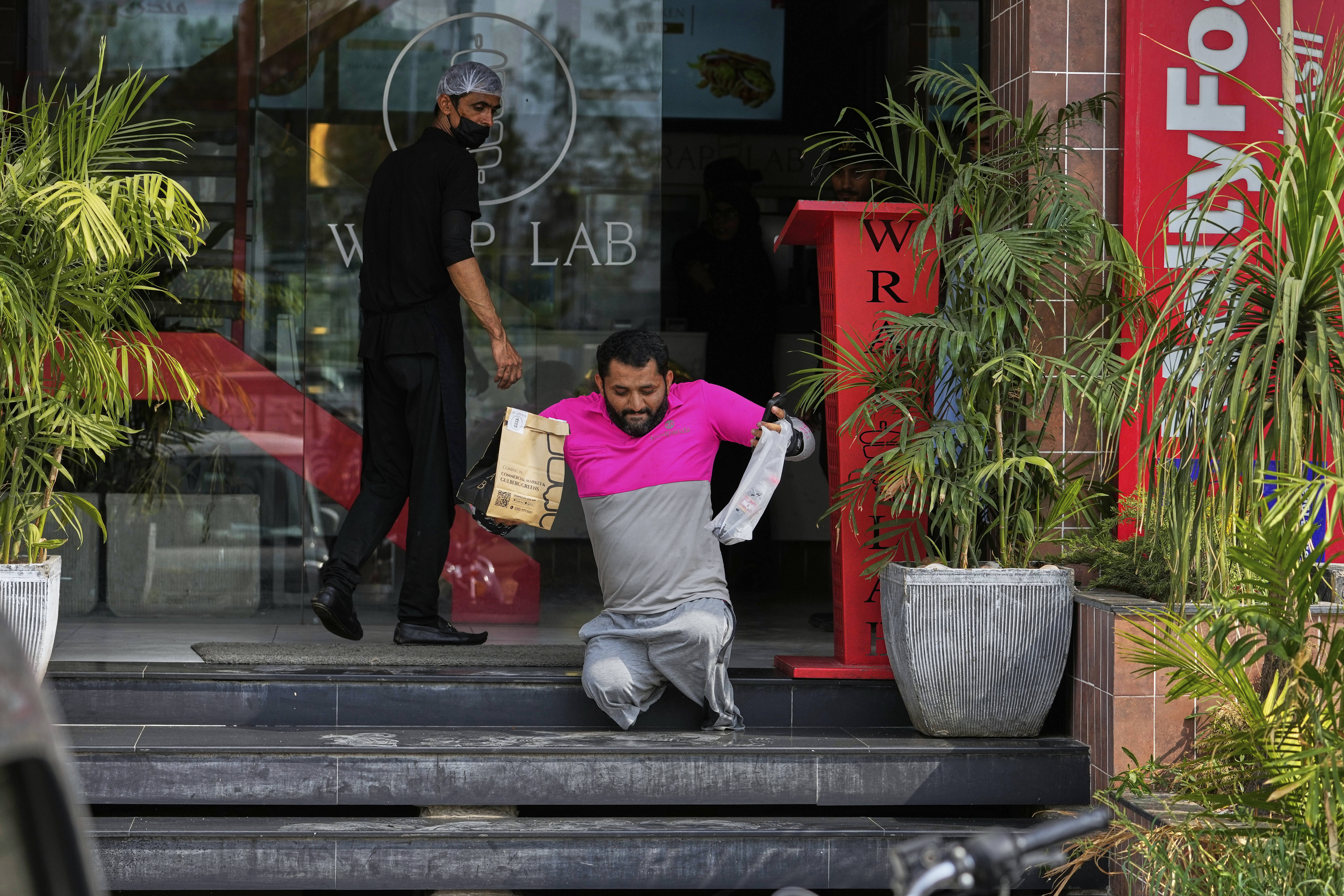 Hamza Ali picks up a meal order for delivery in Islamabad. 