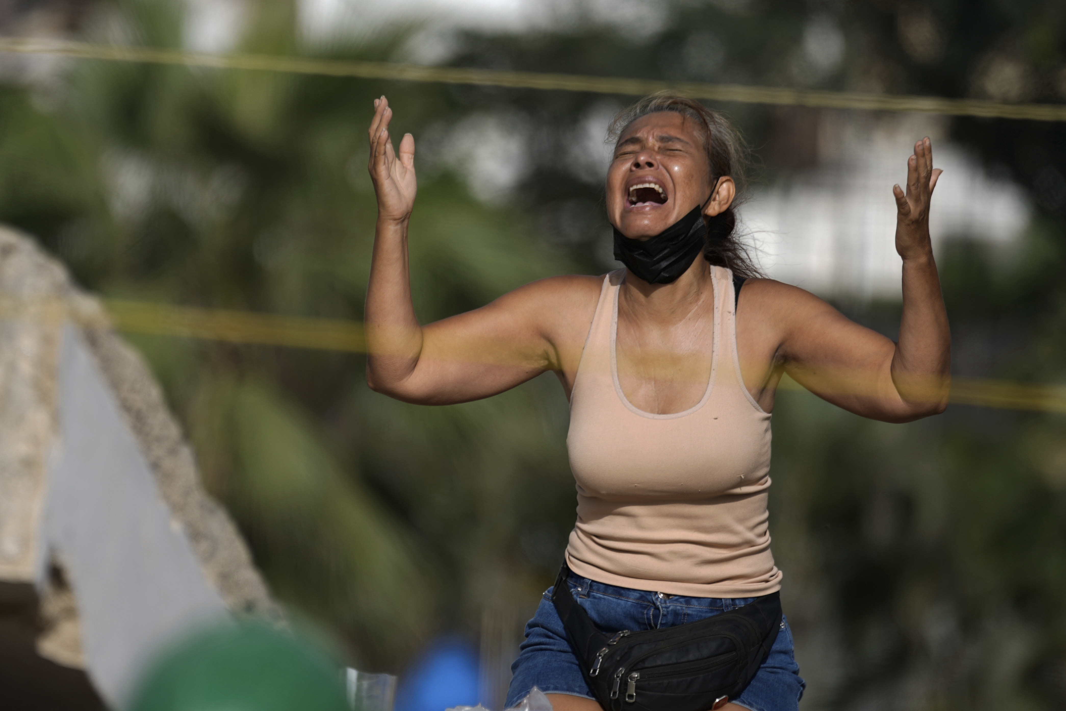 A mother prays as she searches through the rubble of an earthquake-collapsed building for the body of her son in La Guaira. 