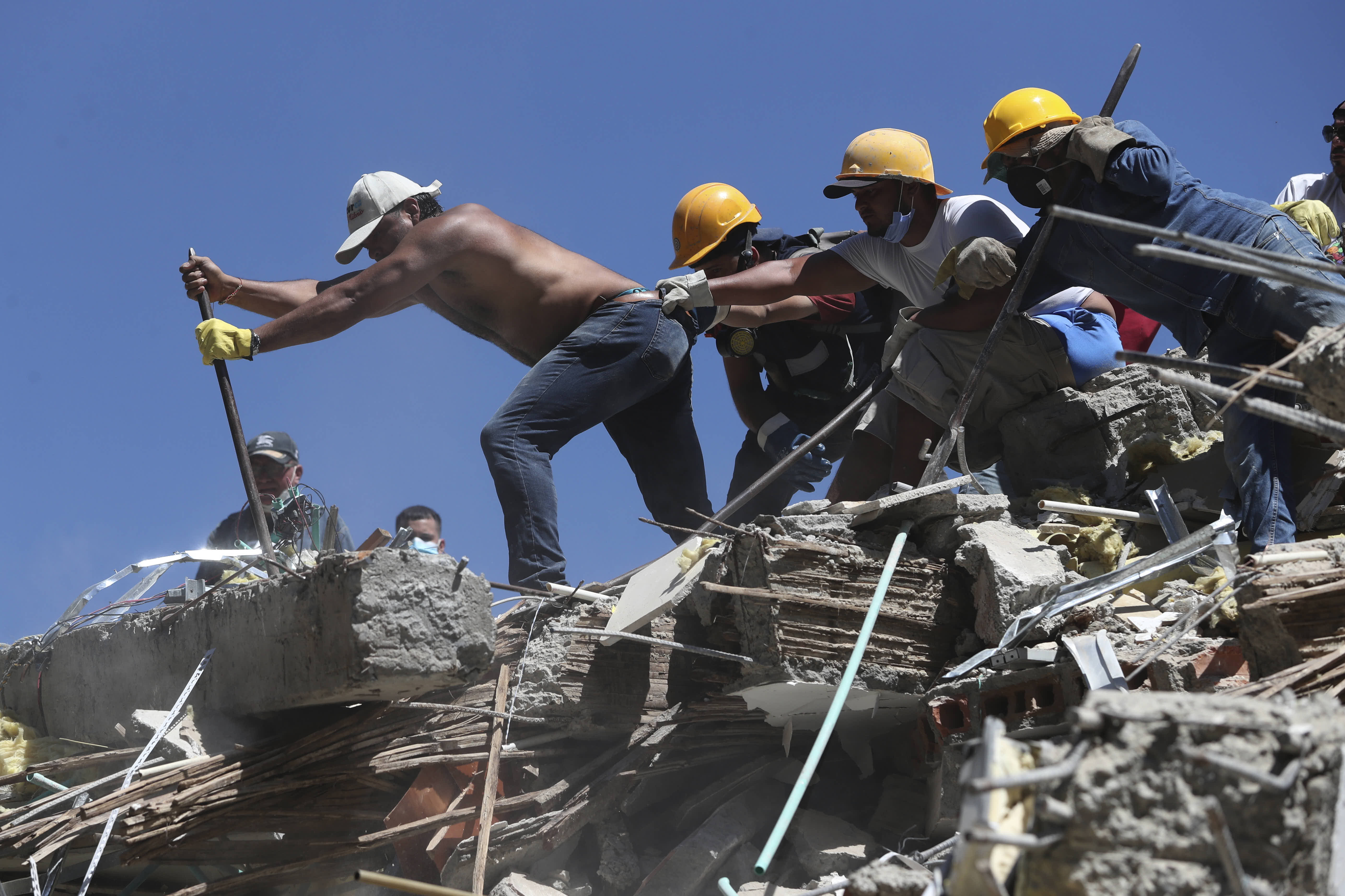 AResidents and rescue workers search through the rubble after a 7.4 magnitude earthquake struck Cali. 