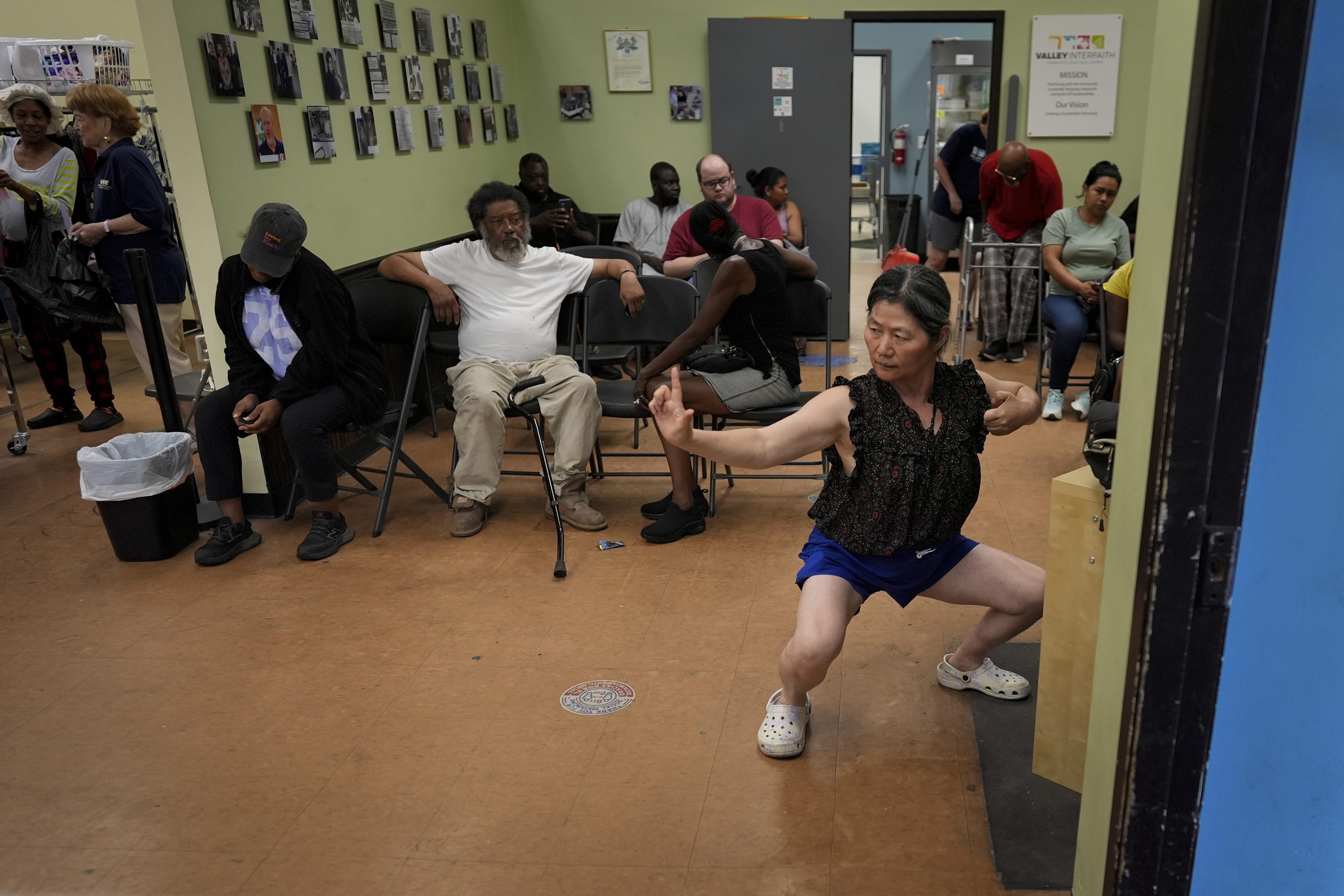 Yun Gao of China practices tai chi while waiting to receive food at the Valley Interfaith Community Resource Center in Lockland, Ohio.