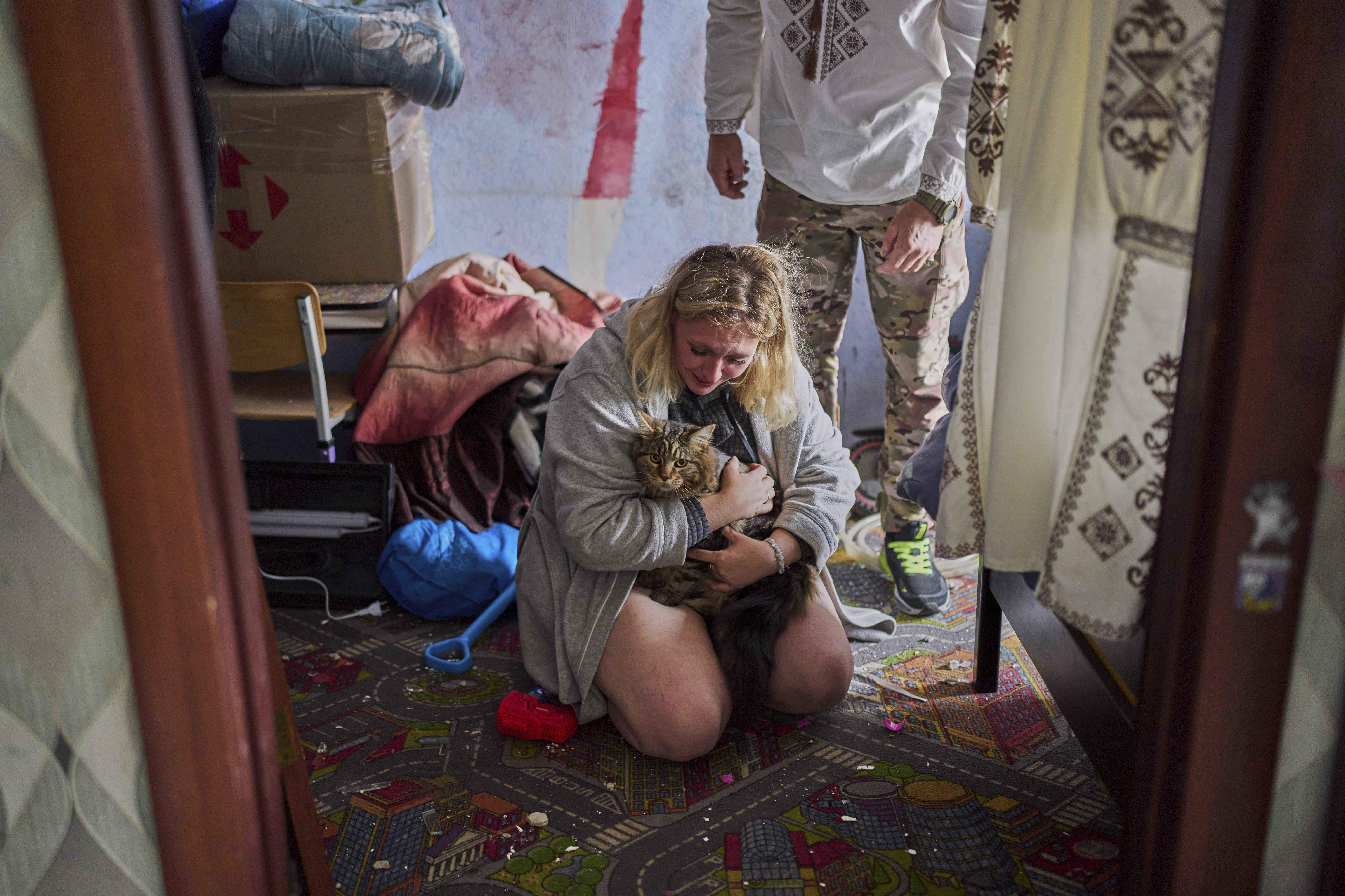Liudmyla Ryzhak embraces her lost cat after finding it in her damaged apartment following a Russian missile and drone attack in Kyiv, Ukraine.