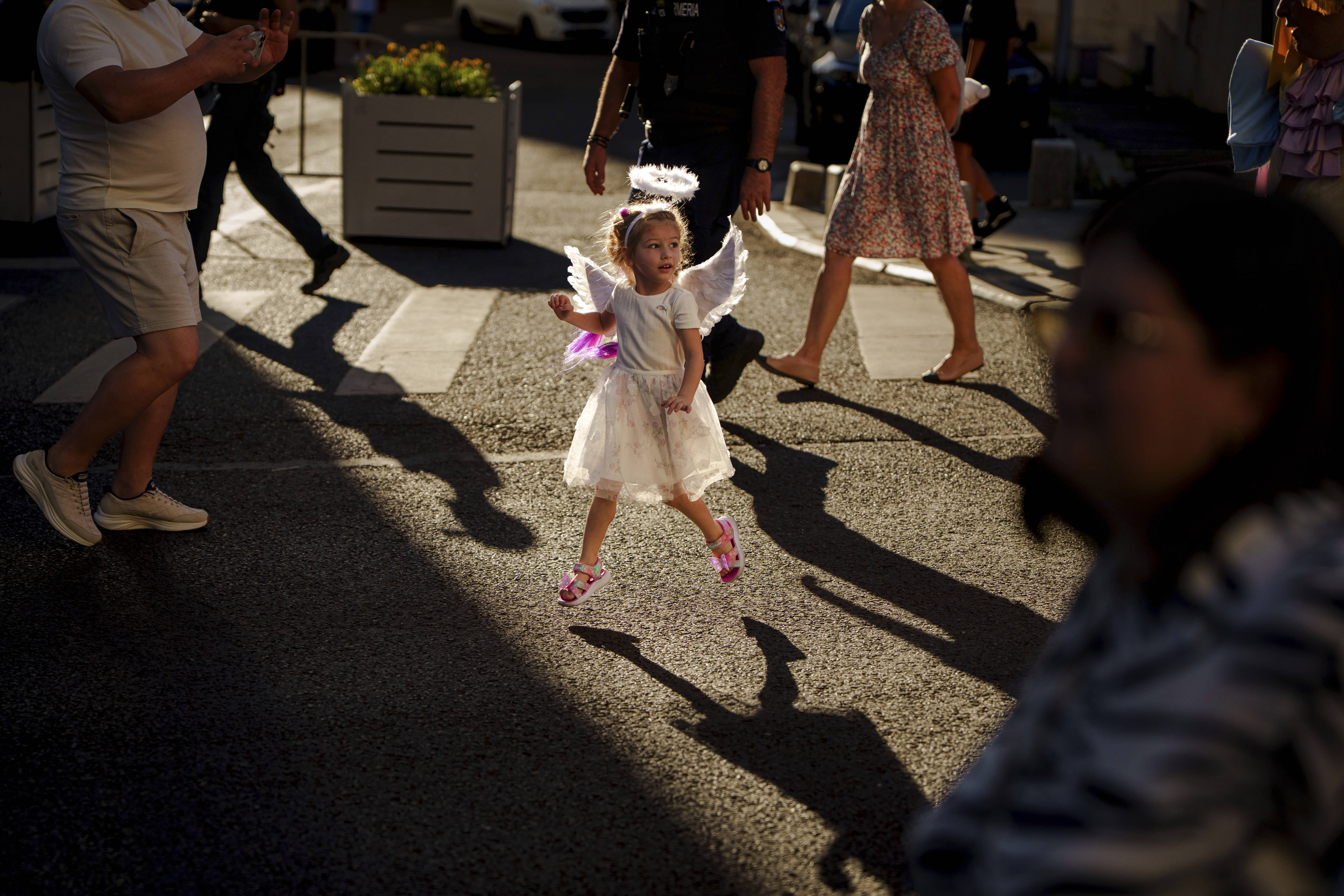 A child dressed as an angel runs during the Little Angels’ Parade in Bucharest, Romania.