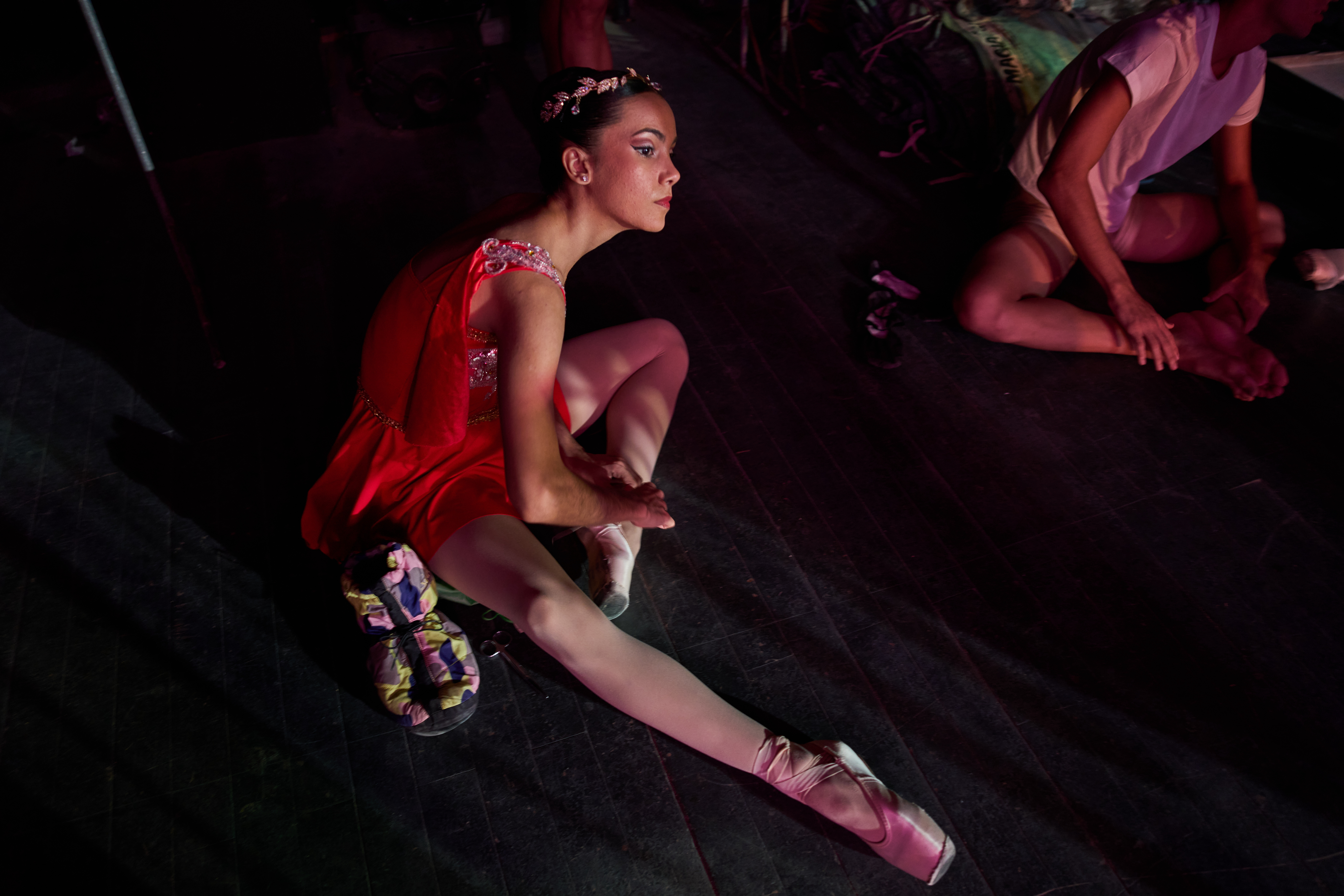 A dancer from the National Ballet of Cuba adjusts her ballet shoes.