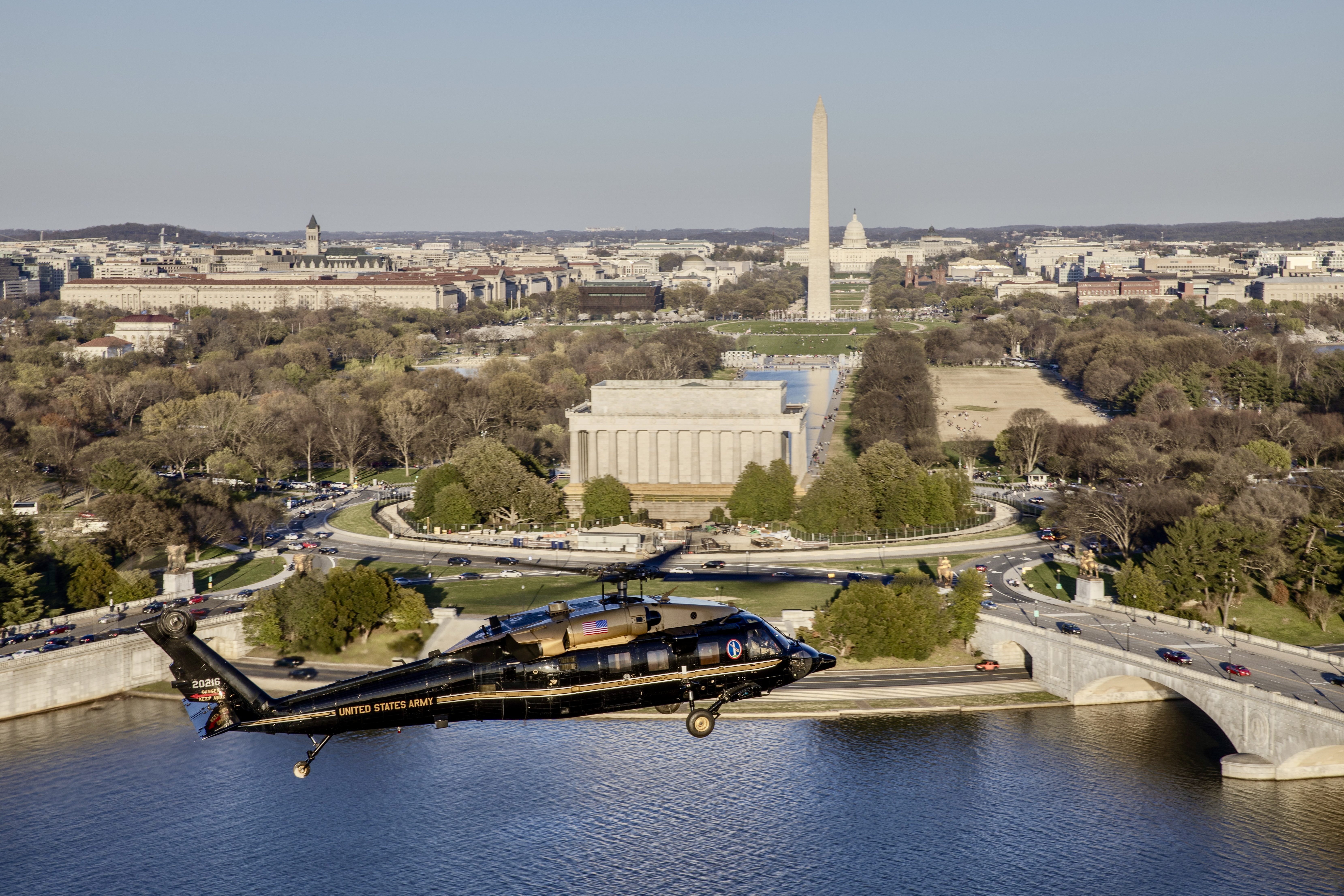 U.S. Army Capt. Chris Bissett and Warrant Officer Eric Mendoza, pilots, and U.S. Army Staff Sgt. Daniel Pechacek, crew chief, fly a VH-60M Black Hawk over the Potomac River near the National Mall, Washington, D.C., March 25, 2024.